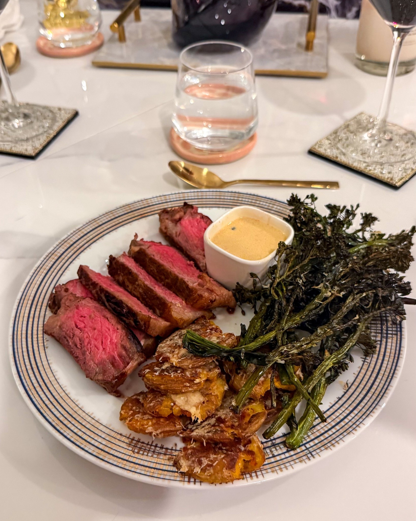 An at-home steakhouse executed to perfection!
NY strip streaks seared in an oven-safe skillet and basted with garlic, butter, rosemary, & thyme. Then finished in the oven! Served with a peppercorn pan sauce. 
Smashed potatoes seasoned with salt & pepper then brushed with garlic pepper and sprinkled with parm. 
Broccolini seasoned with salt, pepper, lemon zest/juice, & red pepper flakes then air fried and dusted with parm  

#LTKHome #LTKfoodie