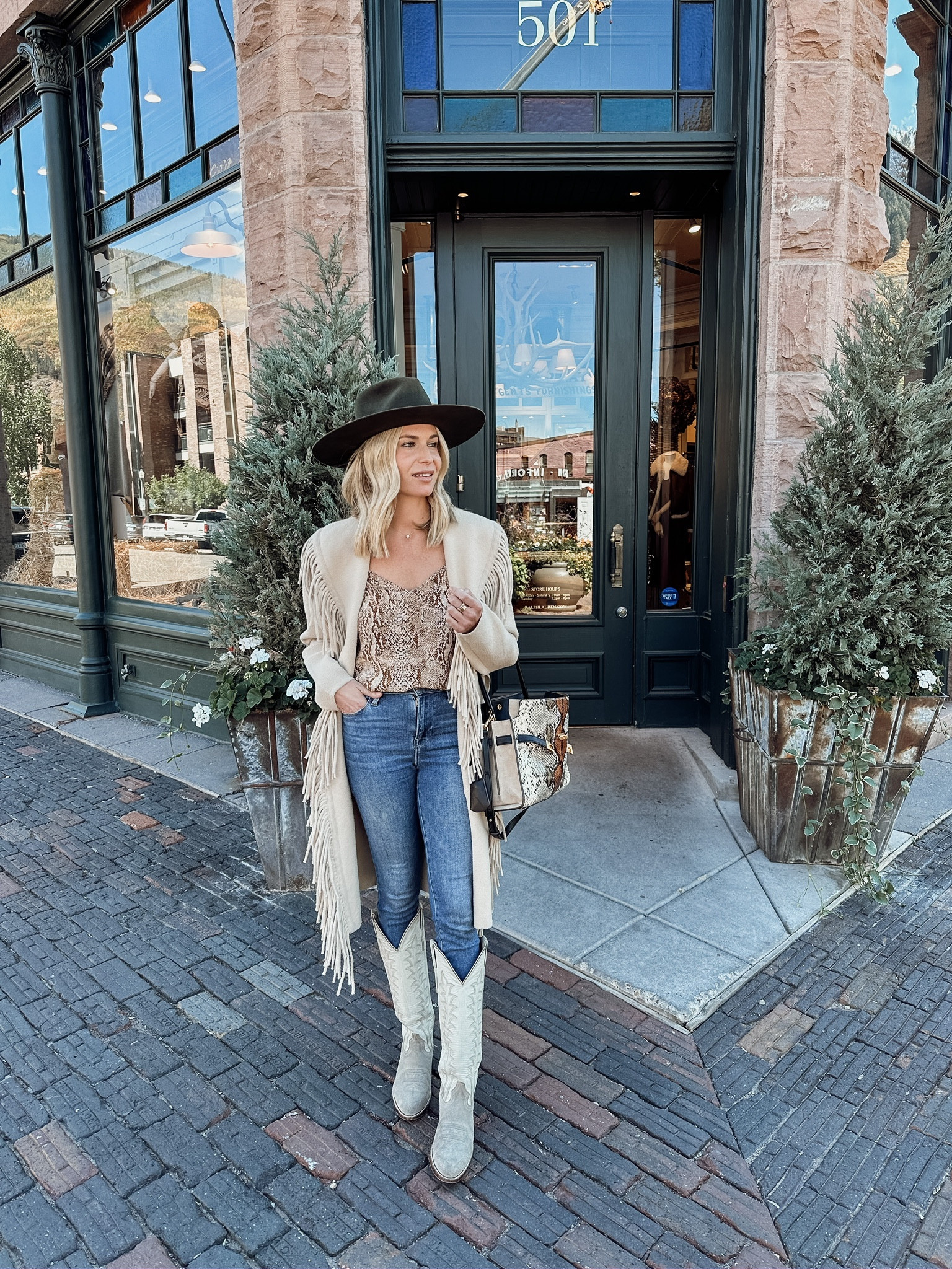 Loving fringe for fall🤍

Fringe jacket, similar snake print cami, dark wash denim, white cowboy boots, similar Tory Burch snakeskin purse, and similar brown hats. 

#LTKworkwear #LTKSeasonal #LTKtravel