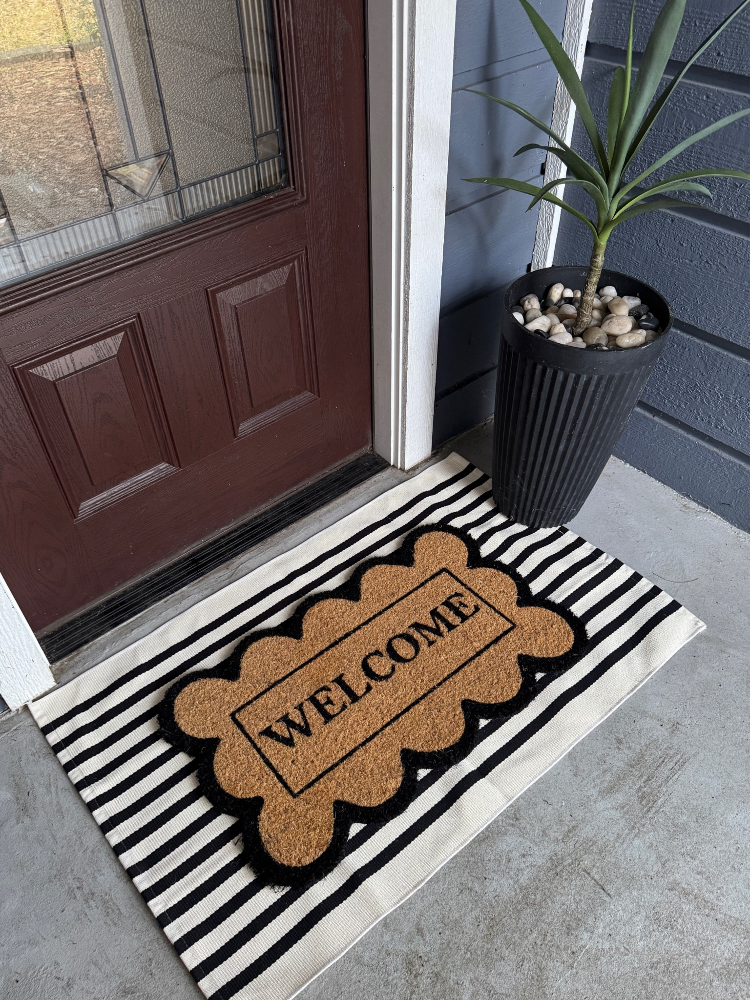 Front porch refresh for spring! Love how the striped rug just instantly elevates the look!! 🖤🌿

#LTKFindsUnder50 #LTKStyleTip #LTKHome