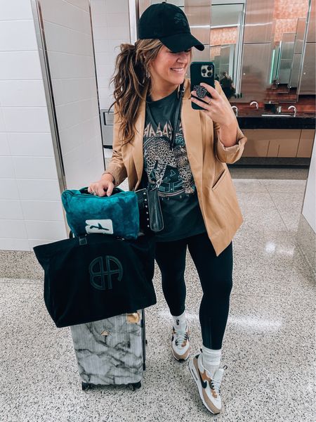 Midsize size 14 Travel outfit! Headed home from the ltk conference 
Faux leather blazer Walmart size 14 (plus size) 
Graphic tee xl
Leggings size large so comfy and strict 
Amazon socks
Nike sneakers
Luggage 
Travel bag I was gifted at conference 
Travel pillow/ blanket
Detroit lions dad hat 


#LTKtravel #LTKcurves #LTKCon