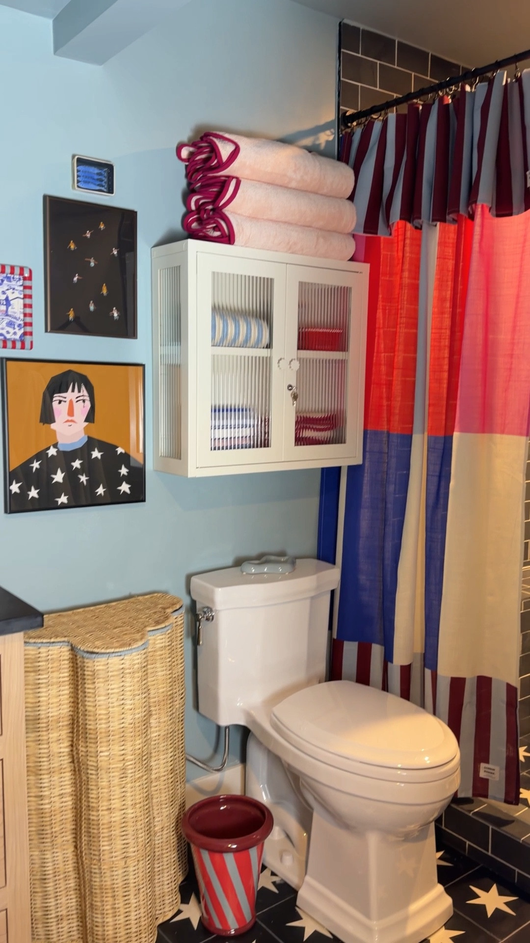 Wait for the shower curtain!!! Yes, totally a fun layer even with glass doors! Adds coziness and some privacy. Blue walls (Dutch Tile Blue) with pops of red made this dark basement bathroom a fun place to visit ♥️ 
@anthropologie #anthropartner