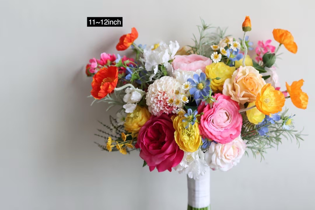 Full of cheerful color and beautiful texture, this vibrant faux flower bouquet by BeeBlooms is perfect for spring or summer weddings. Featuring a playful mix of yellow, orange, hot pink, light blue, and white blooms—including select real-touch flowers—it offers a lifelike look with lasting beauty. Finished with a soft satin ribbon wrap, this bouquet pairs effortlessly with matching boutonnieres and coordinating pieces. Custom wedding packages and color changes are available, making it easy to design florals that fit both your vision and your budget.

#LTKwedding #BridalBouquet #SpringWedding #SummerWedding #ColorfulWedding #FauxFlorals #WeddingInspo #EtsyWedding #BeeBlooms #WeddingDetails

#LTKHome #LTKWedding #LTKSeasonal