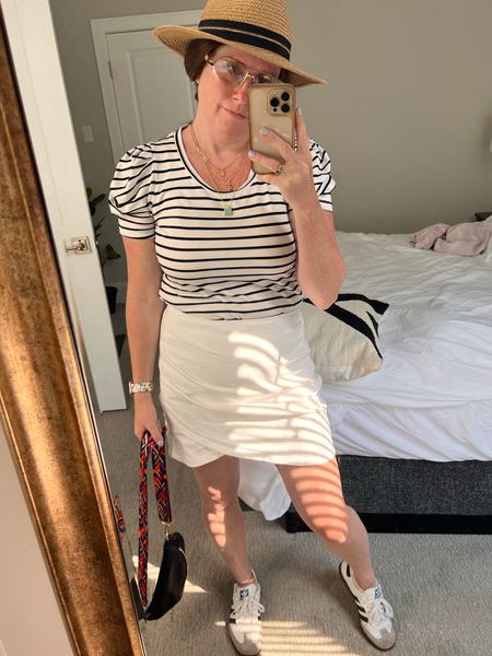 Summer travel outfit day two. Easy skirt and stripes top with puff sleeve details. Essential hat. Crossbody bag and sneakers to style it off. Work to party outfit idea  

#LTKOver40 #LTKTravel #LTKWorkwear