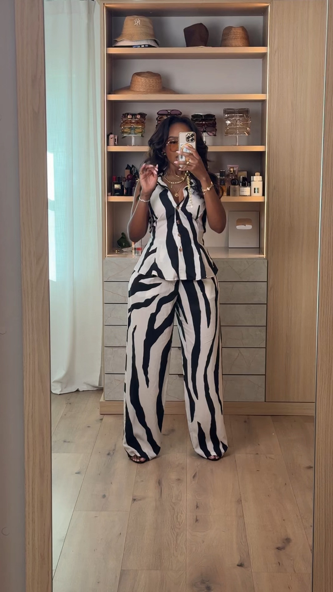 Hi Babes! 🖤🤍✨

This black and white printed set is the definition of effortless chic! I love a matching set that instantly looks put together, and this one is lightweight, flattering, and perfect for everything from vacation to brunch.

✨ Fit Details:
• Wearing a size Small
• Matching sleeveless button-front top
• High-waisted wide leg pants
• Lightweight, breathable fabric
• Styled with layered gold jewelry, oversized sunnies, and black heels

🖤 Where to Wear:
• Vacation sightseeing
• Brunch with the girls
• Resort dinners
• Summer parties
• Date night
• Weekend outings

Matching sets are always a yes because you can wear them together or mix and match with pieces already in your closet!

Everything is linked below!

xx, Kira | IG: KirasFashionFinds

Measurements:
Kira: 5'4" | Size Small | 140 lbs