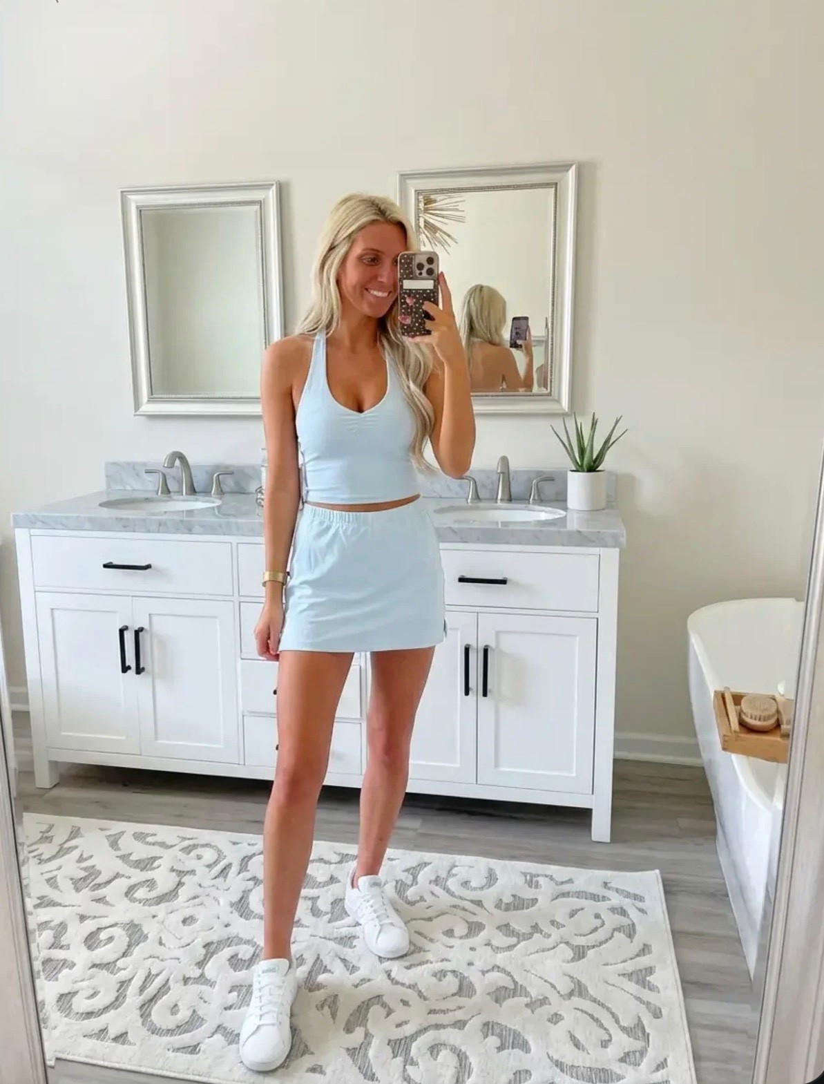 
Bright, lifestyle influencer selfie in a minimalist dressing room mirror. A stylish blonde woman with long beachy waves wears a green and white striped sleeveless polo dress paired with white Adidas sneakers and gold bracelets. The look is sporty-chic and effortless. Neutral dressing room background with soft lighting, clean wood floors, and a relaxed summer vibe. The aesthetic is preppy, travel-ready, and Instagram-worthy — Ralph Lauren meets casual golf resort style. The mood is confident, playful, and polished.

⸻

Caption

Sporty, comfy, and ready for wherever the day goes ✨
This is my favorite kind of outfit — easy, travel-ready, and cute enough for anything from running errands to grabbing lunch or hopping on a flight.

Athleisure but make it preppy chic 💚

— Heidi

⸻

Hashtags

#trendyheidi
#trendywithapassport
#sportychic
#athleisurestyle
#preppystyle
#summeroutfits
#everydaystyle
#adidasstyle
#casualchic
#airportoutfit
#weekendstyle
#tenniscore
#golfstyle
#traveloutfit
#effortlessstyle
#womenwithstyle
#styleinspo
#outfitinspo
#ootdfashion
#everydayfashion
#influencerstyle
#lookbookstyle
#amazonfashionfinds
#casualfashion
#fashionreels


#LTKdayinmylife #LTKgrwm #LTKSpringSale