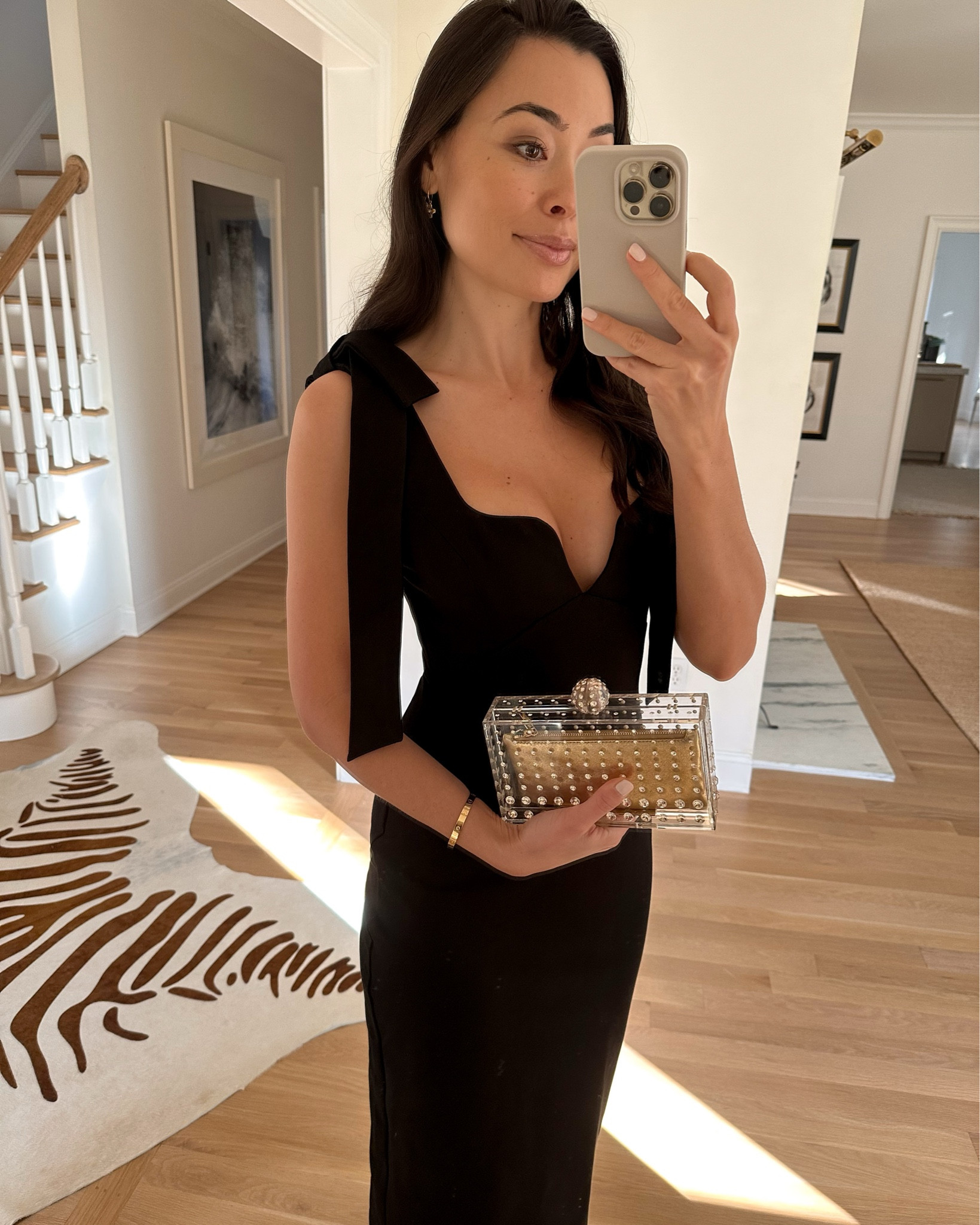 Kat Jamieson wears a black dress with shoulder bows. Lucite gold clutch, cocktail party, holiday outfit, Christmas, wedding guest dress. 

#LTKSeasonal #LTKHoliday #LTKwedding