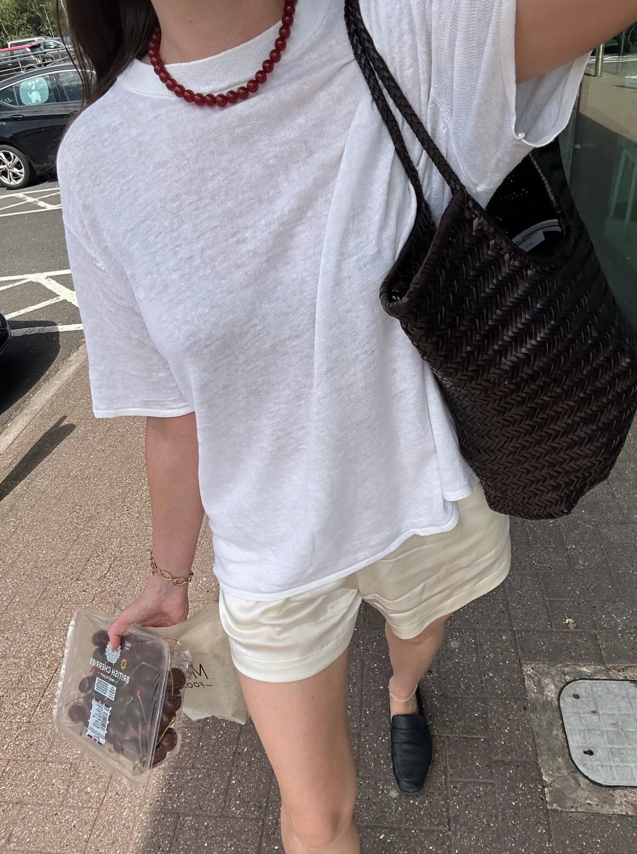 A white linen t-shirt with satin shorts made chic with a red beaded necklace. Easy, breezy, and polished enough for a quick trip to the shops.