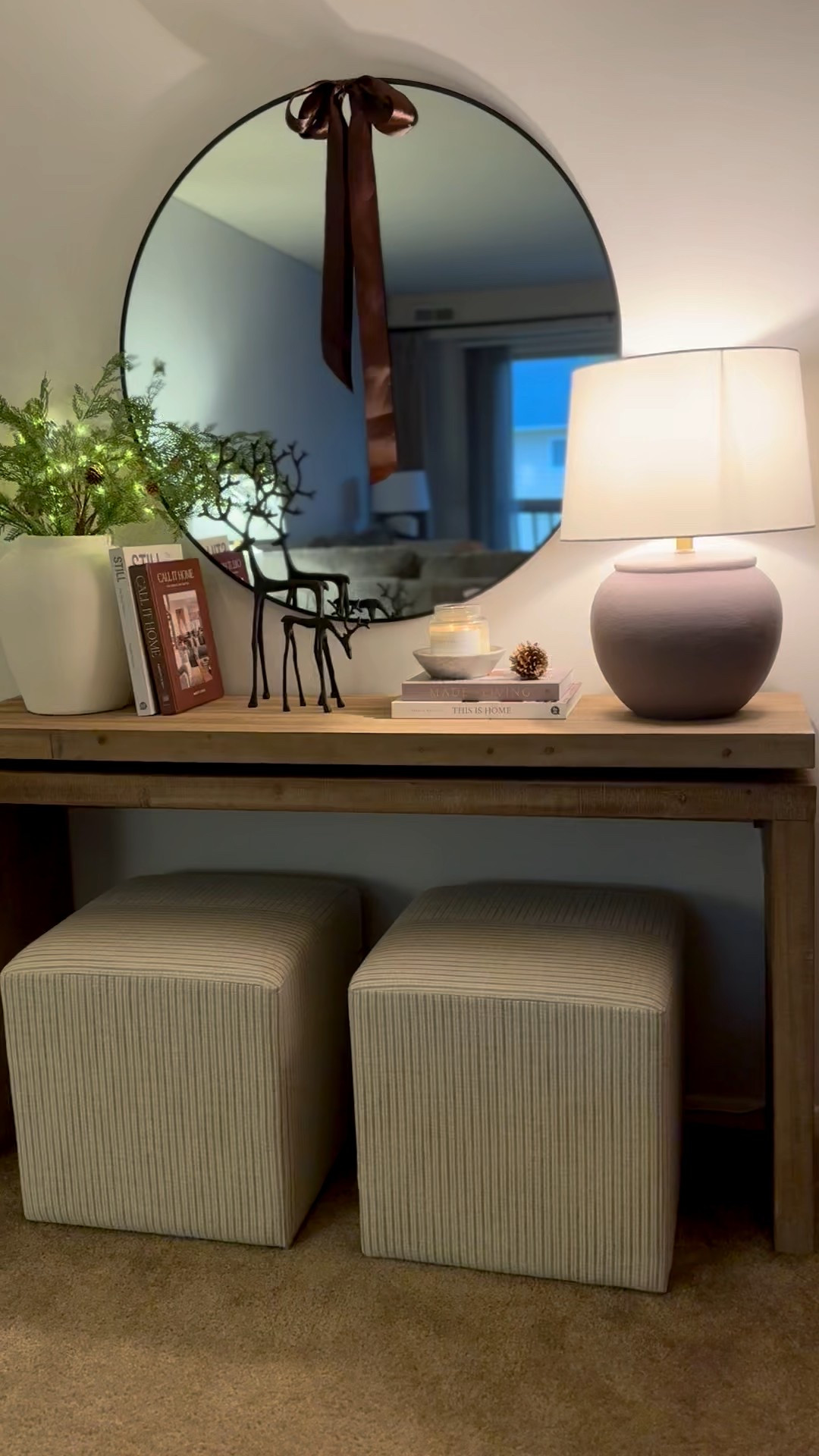 Console table, black reindeer, stripe ottoman, wood console, round mirror, led stems, white vase, coffee table books, candle bowl

#LTKSeasonal #LTKHoliday #LTKHome