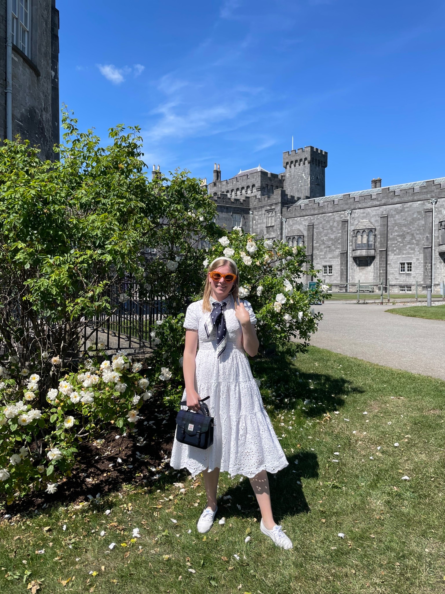 What to wear on a summer day in Ireland. Wore an eyelet aline dress paired with a navy silk scarf and tartan purse when visiting Kilkenny Castle  

#LTKSeasonal