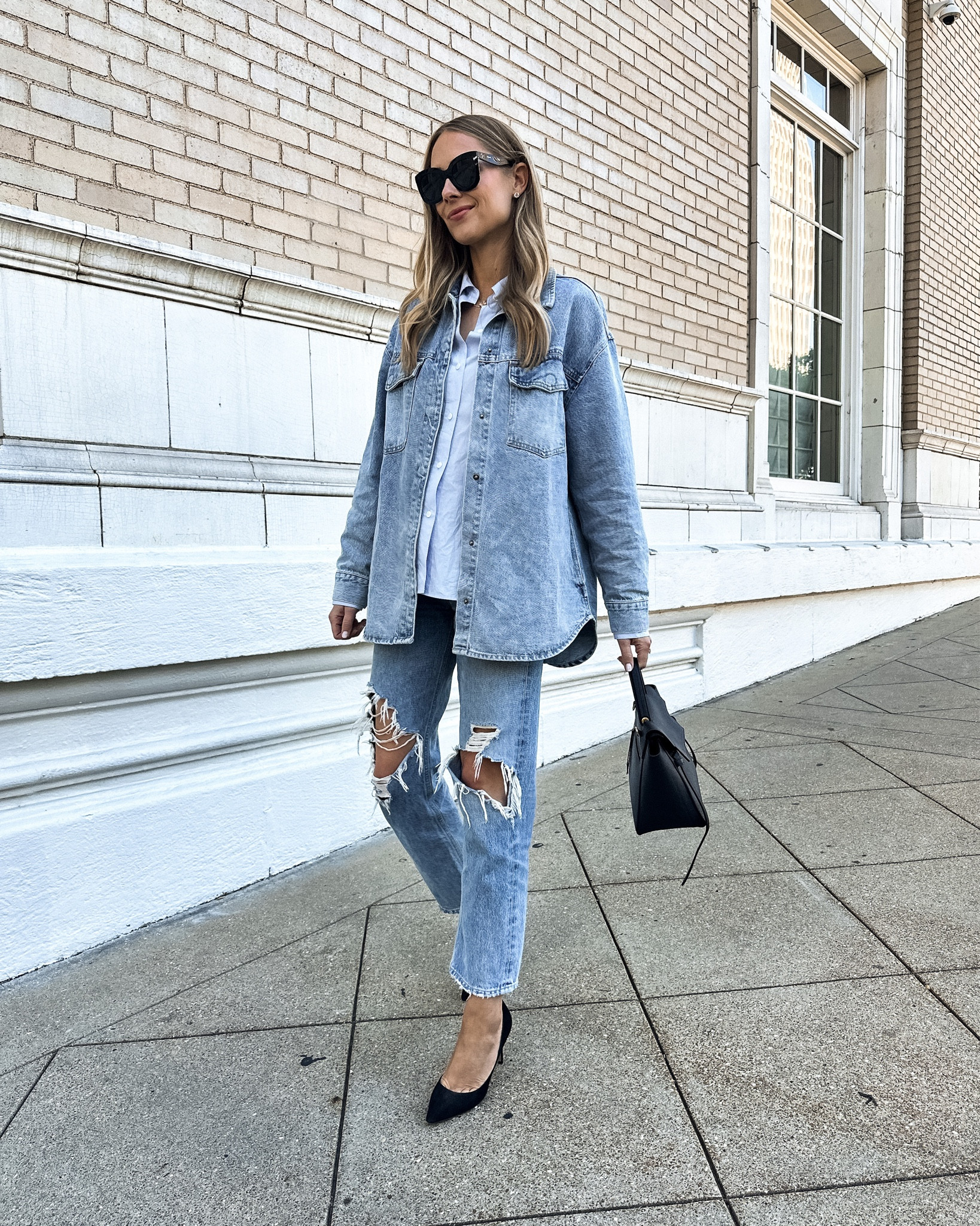 Fashion Jackson wearing oversized denim shirt jacket (medium) blue boyfriend shirt (JACKSON15 discount), AGOLDE ripped jeans, black pumps #fashionjackson #jeans #springoutfit 

#LTKstyletip #LTKshoecrush #LTKunder100