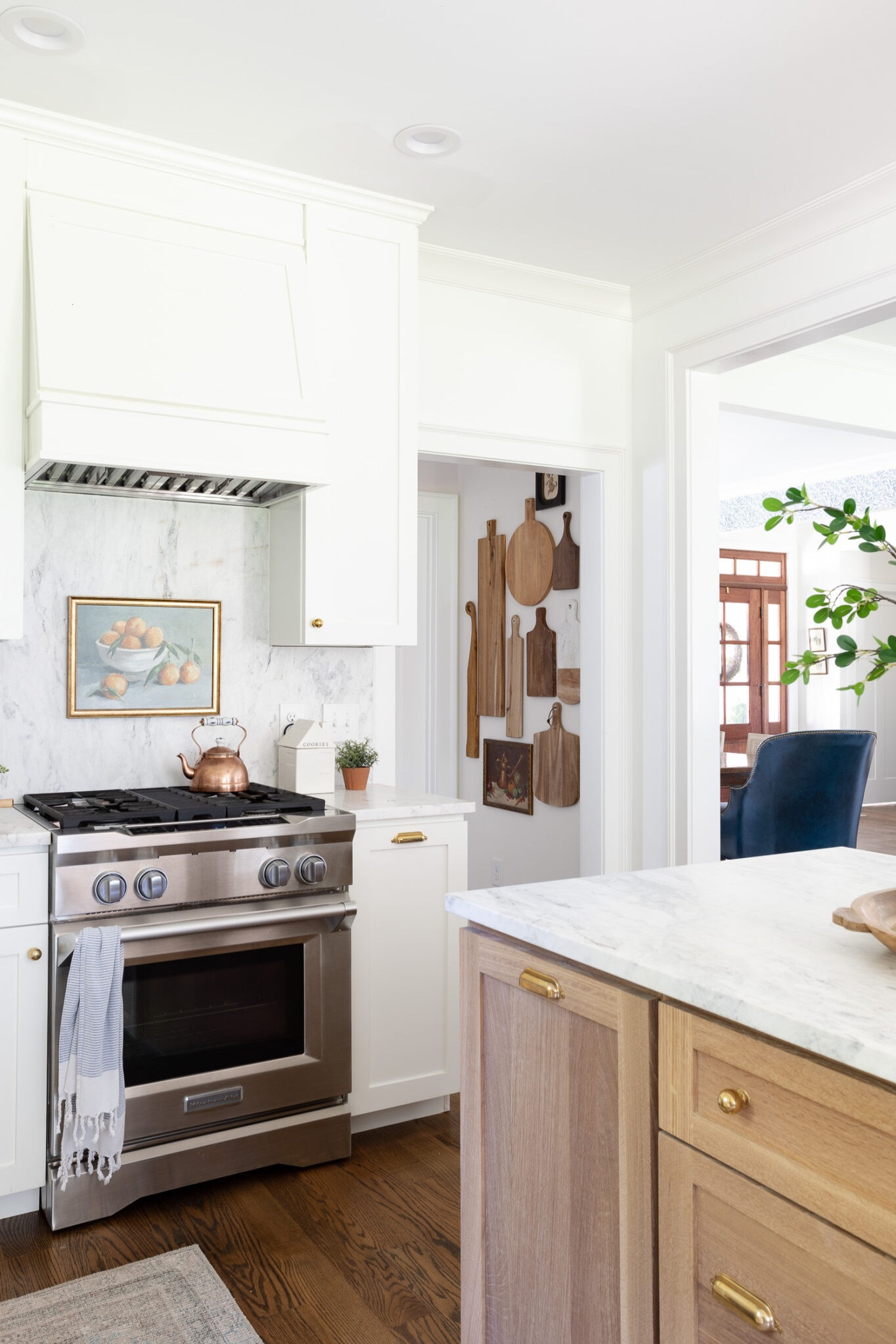 Wood cutting gallery board on the kitchen hallway. White kitchen, wood island, marble countertops, kitchen decor, wood serving boards 

#LTKfindsunder50 #LTKhome #LTKSeasonal