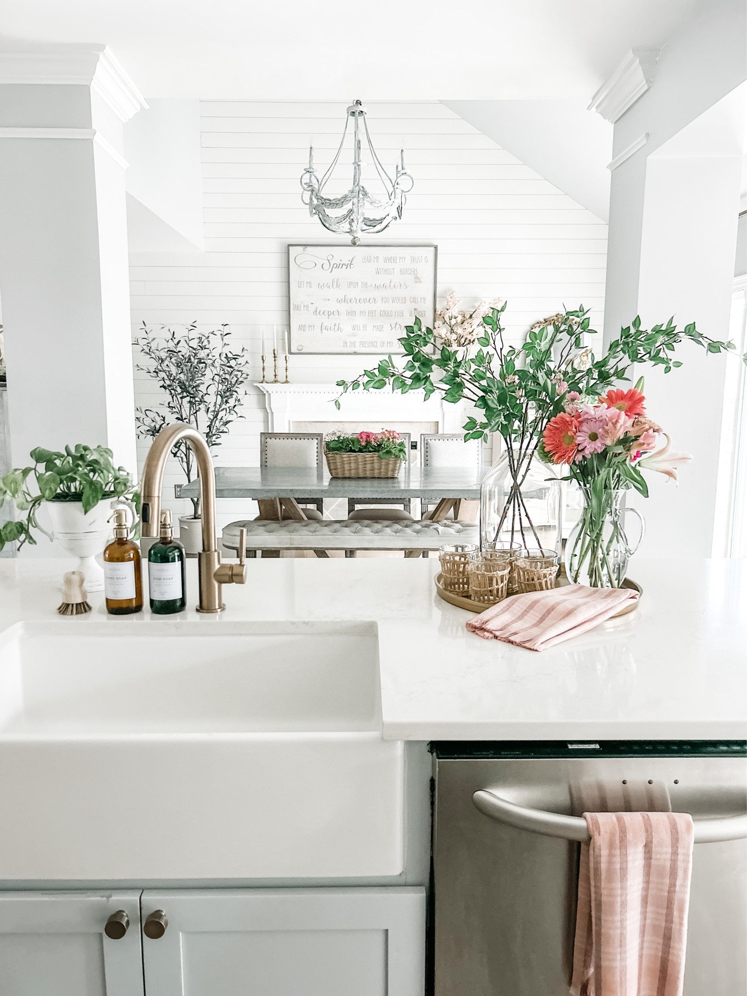 Loving this Spring decor in the kitchen! 
These artificial branch stems wake up the room!

Kitchen decor, white sink, Farmhouse sink, champagne bronze kitchen faucet, warm gold faucet, Studio McGee Olive Tree, Artificial Tree, Faux tree, rattan wrapped glassware, cane drinking glasses, round gold tray, round tray, kitchen hand towel, pink kitchen towel, tall glass pitcher with handle, artificial branch stems, faux stems, artificial greenery, knob, warm gold Knob, kitchen hardware, amber glass soap dispenser, pot scrubber, palm bamboo scrub brush, Spring decor, Target decor.
#kitchen #kitchenisland #kitchendecor


#LTKhome #LTKFind #LTKstyletip