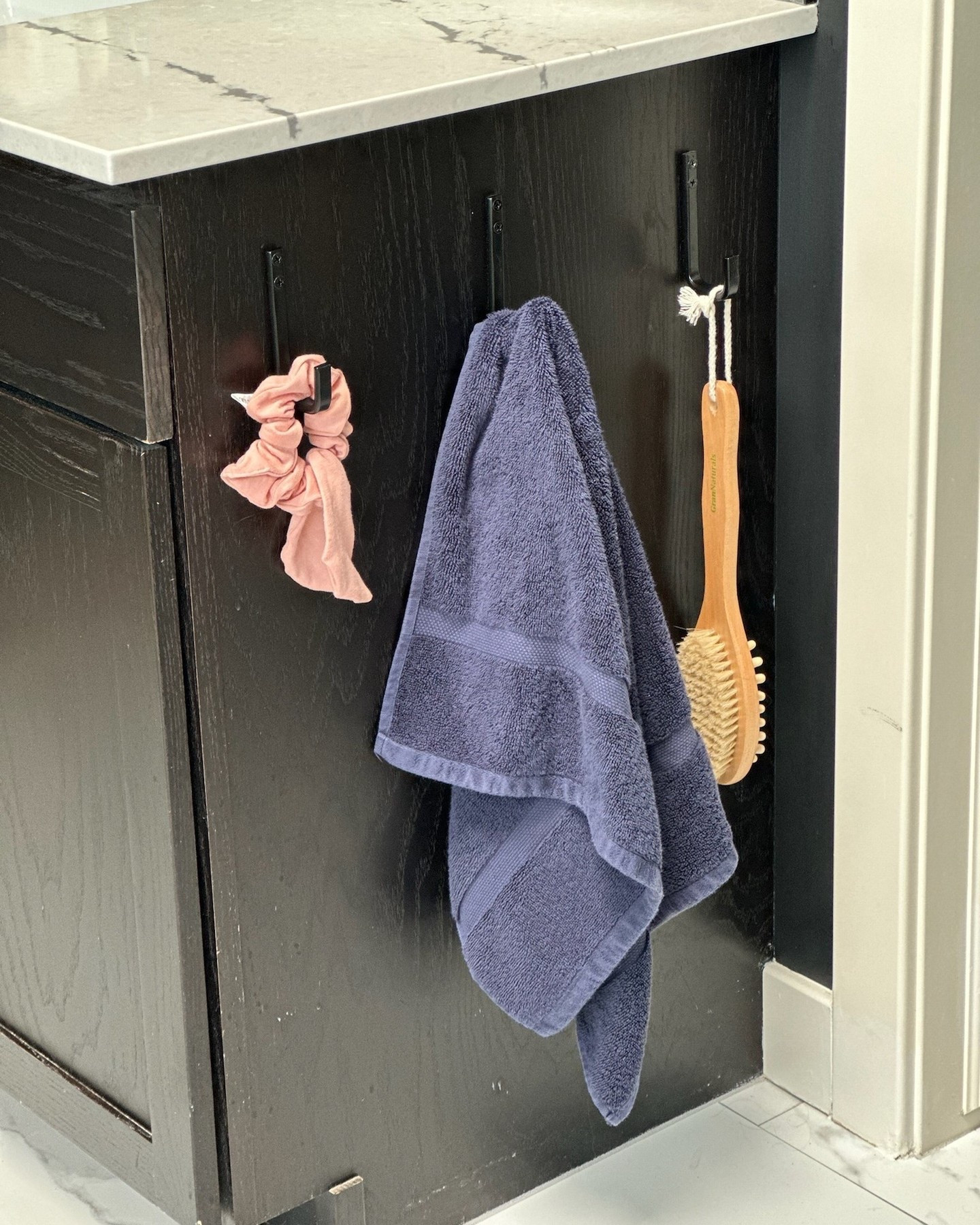 Want a quick way to clear your bathroom counters? Add hooks to the sides of your vanity! Perfect for hanging hair tools, towels, or baskets for extra storage. Simple, easy, and clutter-free! ✨ 

#HomeOrganization #BathroomHack #DeclutterYourSpace #GetOrganized #MasterBath #Ensuite #ClearCounters
