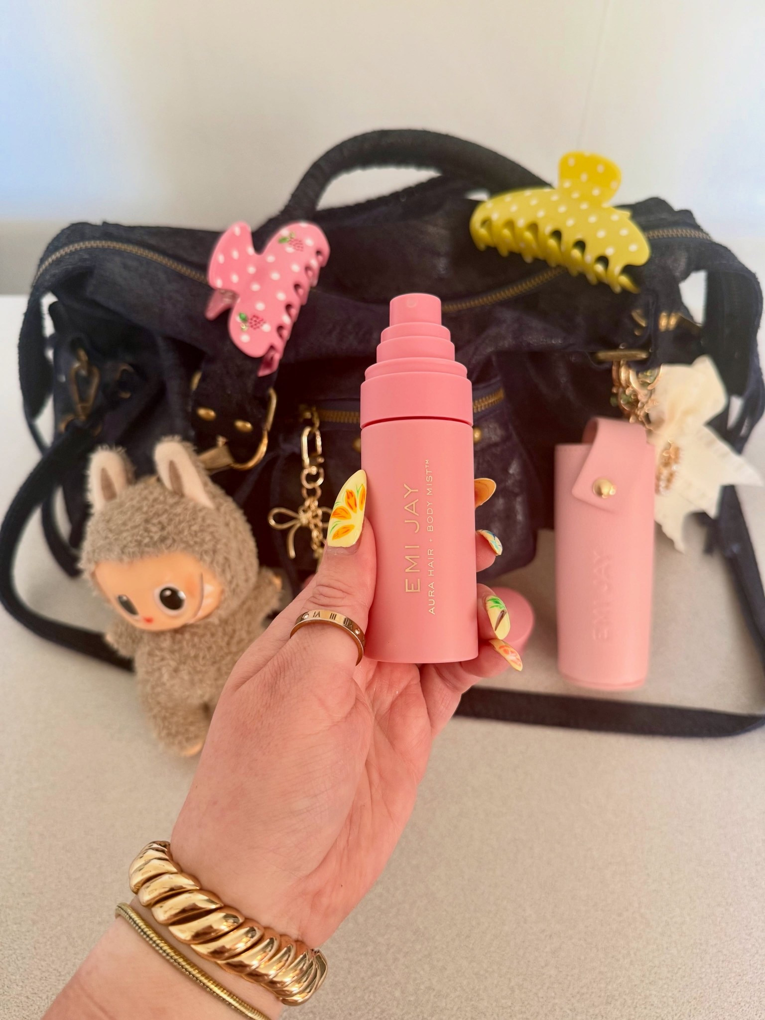@emijayinc aura mist has the cutest little leather case that clips right onto your bag - so now my hair perfume is a bag charm and i will not be taking questions 🎀

the claw clips clipped on too bc we’re committed over here 

follow for more pink Wednesday 🎀

Emi jay claw clips . Emi jay aura mist . Emi jay lychee baby . Pink Wednesday . Pink aesthetic . What’s on my bag . Bag charms