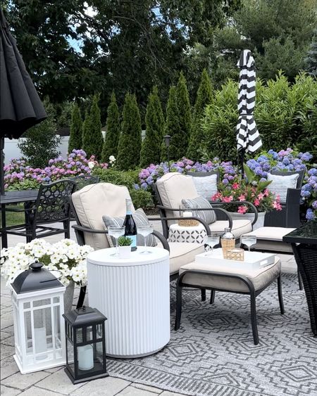 Summer backyard. Shop cooler table, pillows on sale, outdoor area rug, umbrellas, coupe glasses, tray, cocktail shaker, outdoor seating. 

#LTKSaleAlert #LTKHome #LTKSeasonal