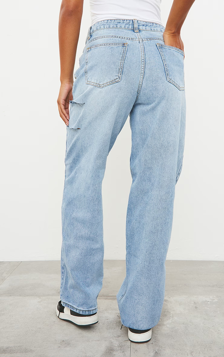 Jean boyfriend baggy bleu clair délavé à taille basse asymétrique et cuisses fendues | PrettyLittleThing (FR)