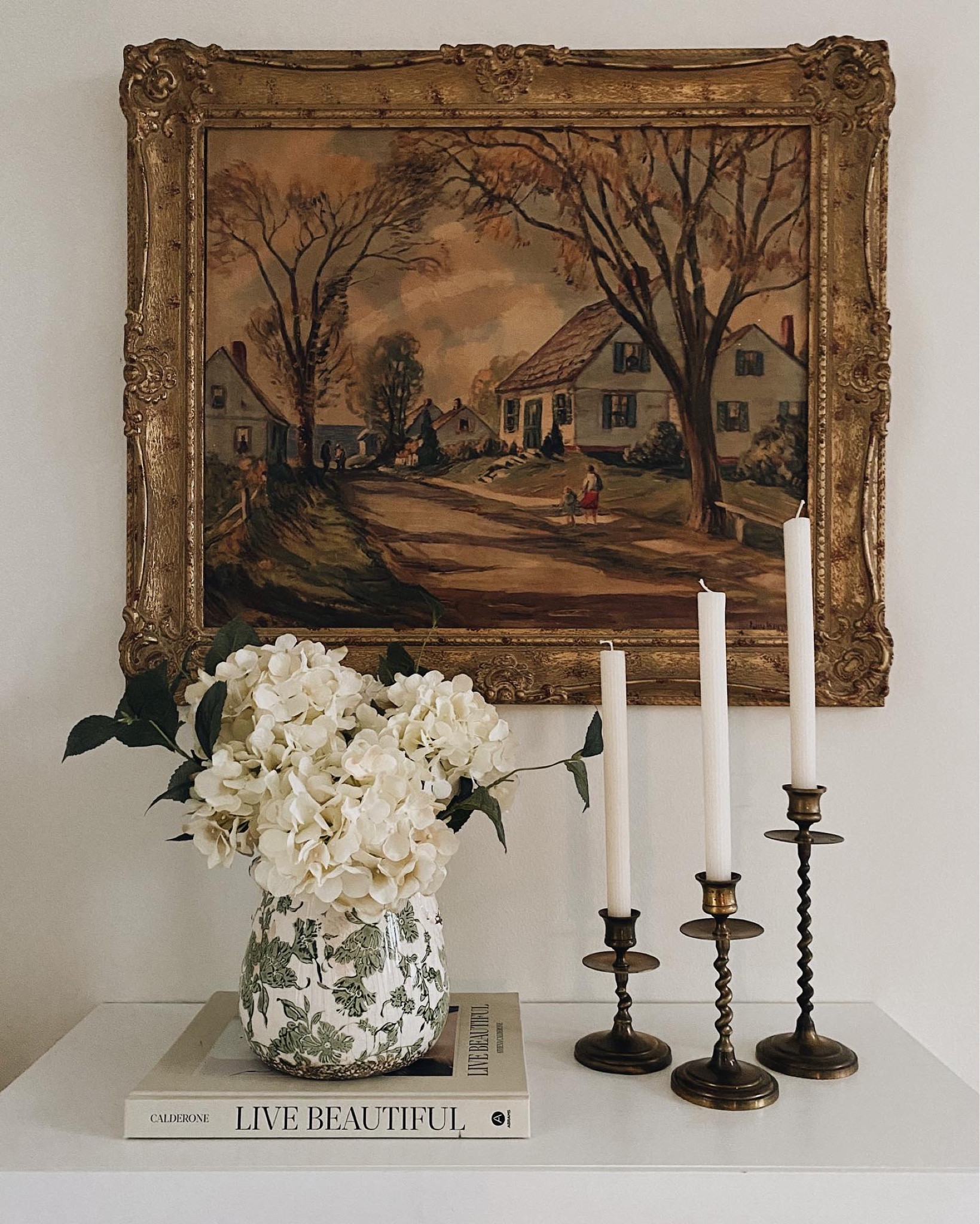 Shop our little entryway “table,” which is actually a DIY radiator cover! 
The artwork is from my grandmother & brass taper candle holders are from my mother. 

#LTKfindsunder50 #LTKstyletip #LTKhome