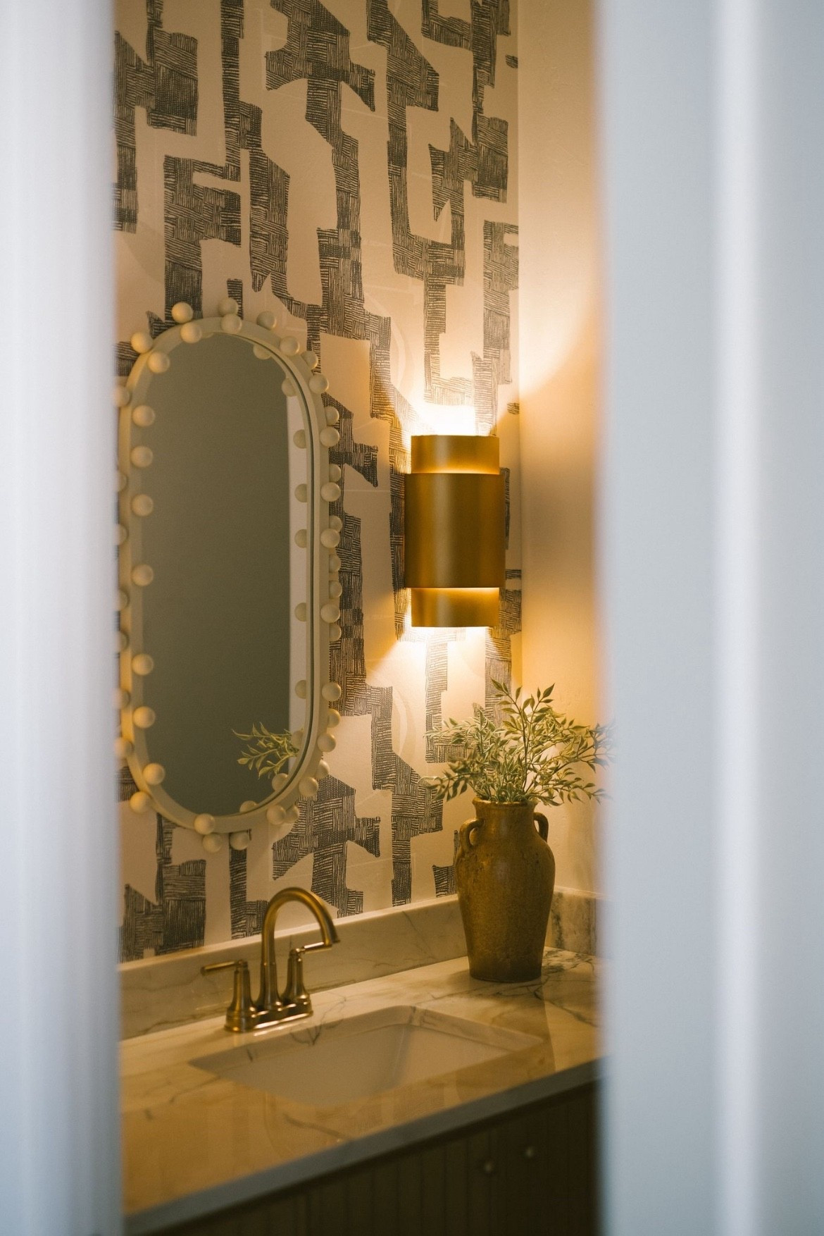 This graphic wallpaper gave this powder bath the personality it needed.
I love using bold prints in small spaces — they create a high-impact moment without overwhelming the rest of the home. This one adds depth and movement while still keeping things neutral. Tap to shop this exact York Wallcoverings print and browse a few of my favorite statement patterns.