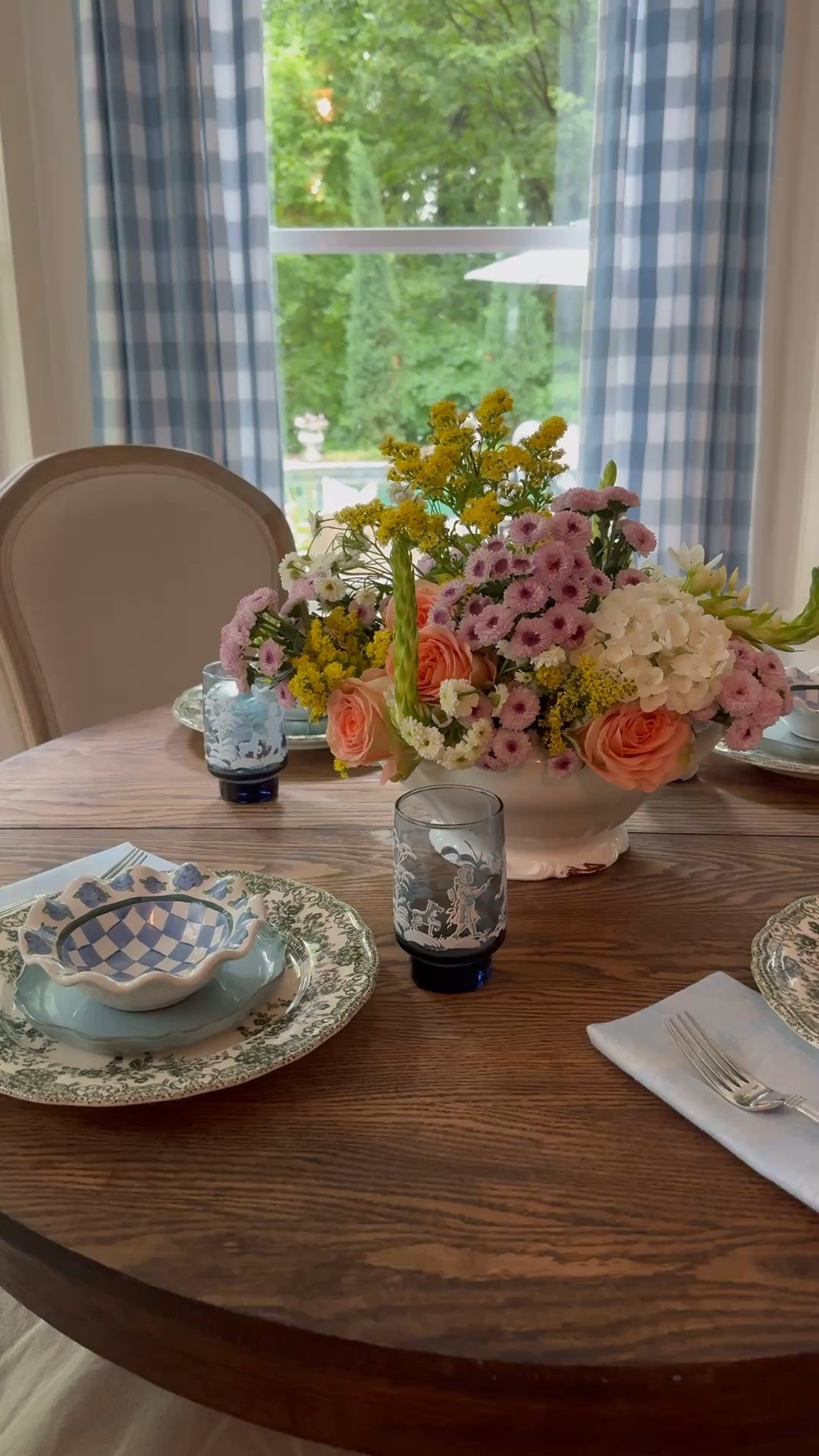 French inspired table setting. Linen napkins, custom check curtains, curved upholstered dining chairs either cushion, vintage blue glasses, vintage tumblers.

#LTKHome #LTKSeasonal #LTKSaleAlert