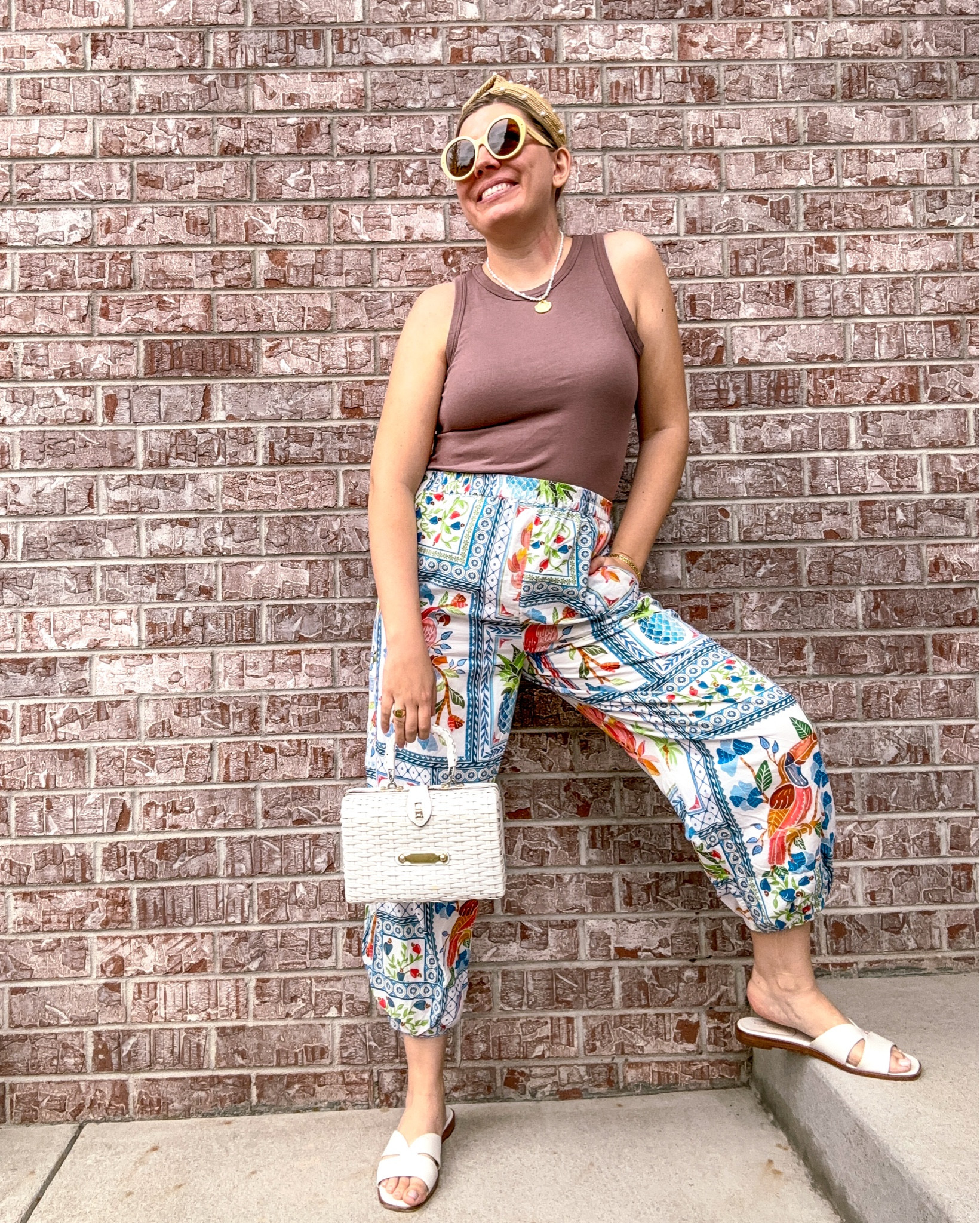 Look 11
Tropical Luxe 🌴 
I often share Farm Rio dresses… but let’s talk separates. These pants are a rental from Armoire and I’m obsessed. The silhouette is breezy, easy, and fun - exactly the kind of piece that proves comfy + casual does not have to be boring.

I dressed them up a bit with accessories to complete the look. The best part is that the colors make this pair a perfect transitional look - light + airy enough for warm temps, but the tones read late summer sliding into early fall.

If you’ve been curious about clothing rentals, I’ll drop a coupon for Armoire in my bio/over on LTK so you can try it at a discount!

✨ Tropical Luxe is my capsule collection for maximalists ✨ A curated series of late-summer looks designed to celebrate vibrant prints, rich textures, and silhouettes that feel both breezy and elevated. Think of it as luxe dressing for the hottest days of the year — a little bold, a little playful, and entirely unforgettable.

Armoire coupon:
https://www.armoire.style/refer/katbondstyle

About this series:

Pants - Farm Rio (similar linked)
Tank - Target (linked)
Sunglasses - Gucci (linked)
Headband - Target (similar linked)
Necklace - Rocksbox (similar linked)
Bracelets - Target/Rocksbox (similar linked)
Ring - Marleylilly (linked)
Bag - Vintage (similar linked)
Sandals - Kate Spade (similar linked)

#FarmRio #FarmRioStyle #FarmRioLovers #TropicalLuxe #SummerStyle #ResortWear #CapsuleWardrobe #OOTDInspo #PatternPlay #TransitionalStyle #ArmoireStyle

#LTKSeasonal #LTKSaleAlert #LTKStyleTip