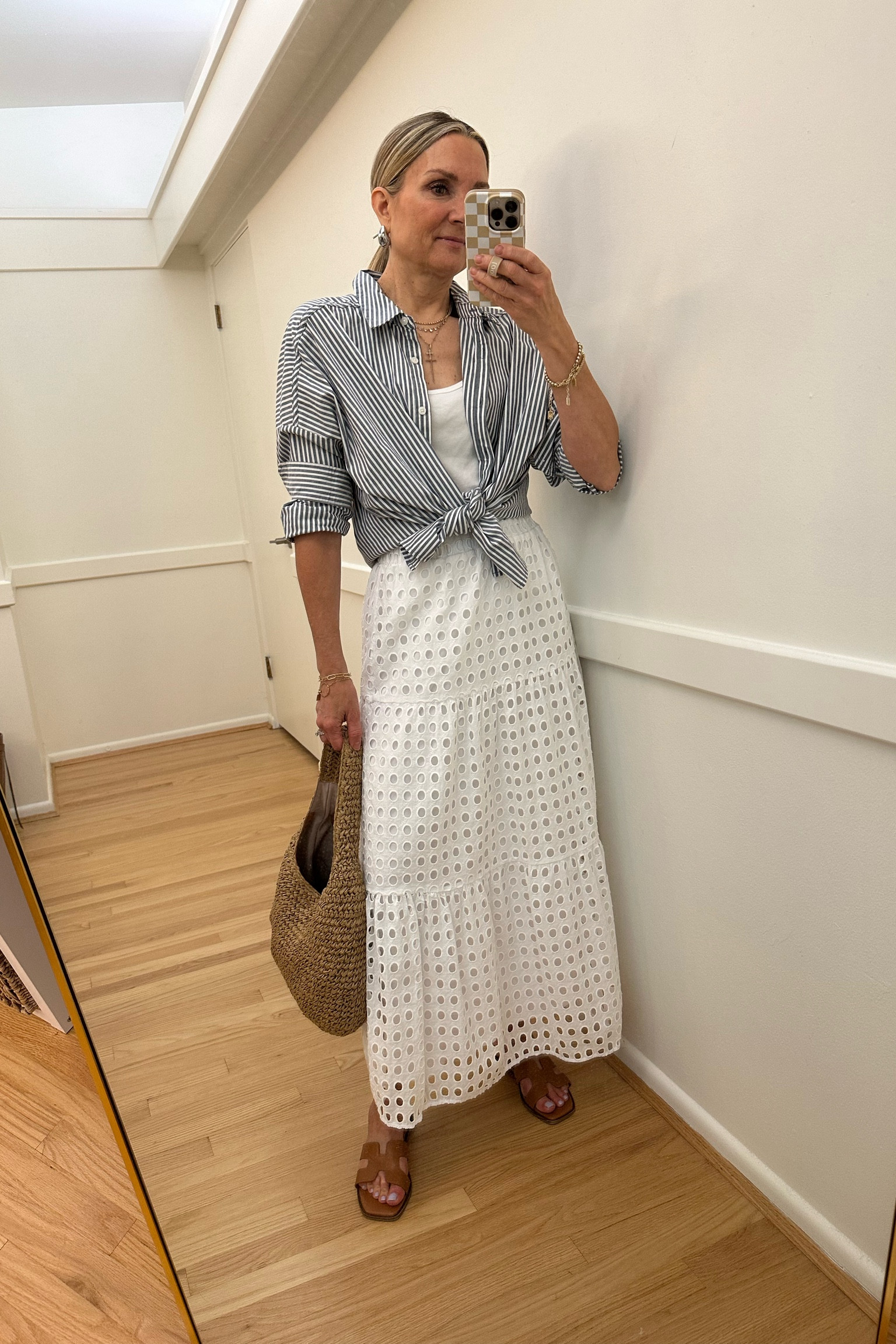 Current favorite white eyelet midi skirt! Wearing xs. Summer dress, summer outfit, vacation outfit, work outfit, kohls, splendid striped button up, raffia shoulder bag  

#LTKOver40 #LTKSaleAlert #LTKFindsUnder50