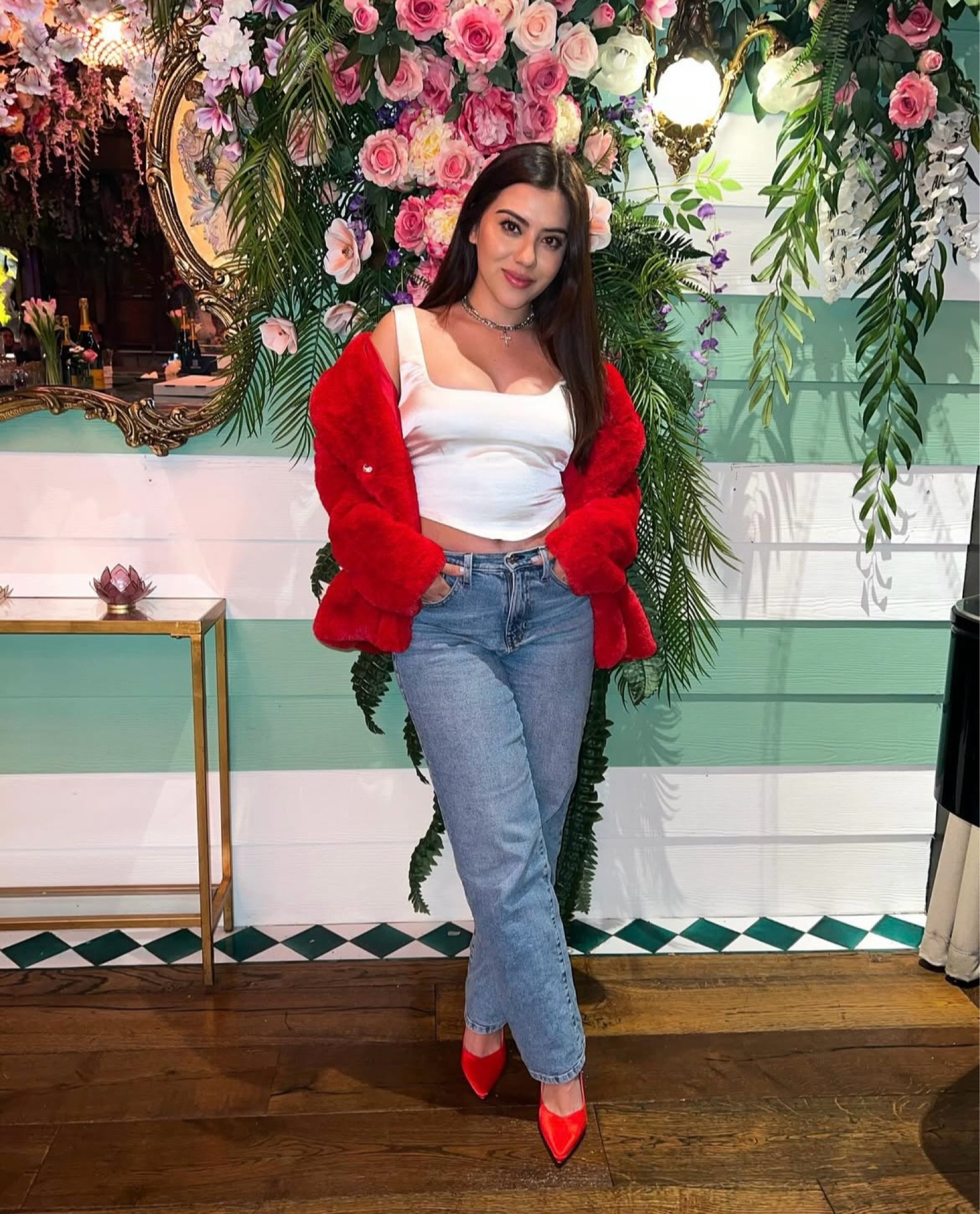 This Valentine’s Day outfit is a chic and stylish mix of casual and statement pieces, featuring a white crop top with a structured neckline, paired with high-waisted blue jeans for a relaxed yet flattering fit. The bold red faux fur jacket adds a touch of glam and warmth, perfectly complemented by matching red pointed-toe heels for a coordinated and eye-catching pop of color. Accessories like a delicate choker necklace complete the look, enhancing its trendy and feminine appeal. #valentinesday #galentines 

#LTKSeasonal