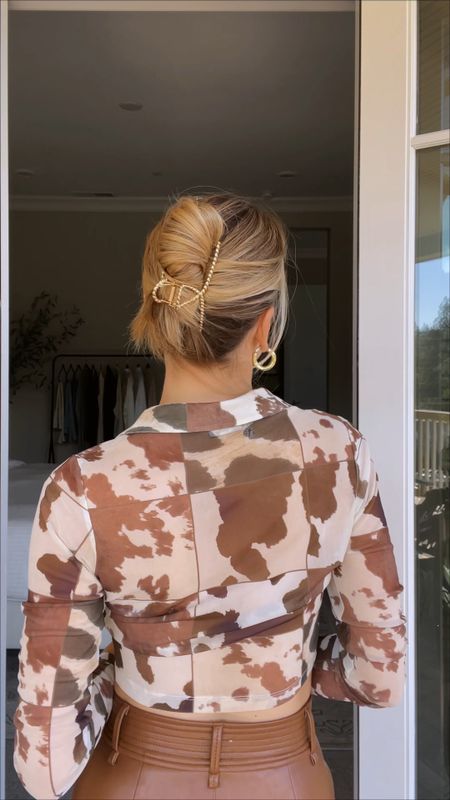 Twist, bun, clip 🌀💁‍♀️ Gather your hair into a low ponytail. Hold the base with your left hand as you begin twisting the hair clockwise. Wrap the hair around itself as you continue to twist and form a bun. Once the bun is in place, pull the bottom of the bun to the top and secure with a claw clip.

#LTKbeauty #LTKunder50 #LTKSeasonal