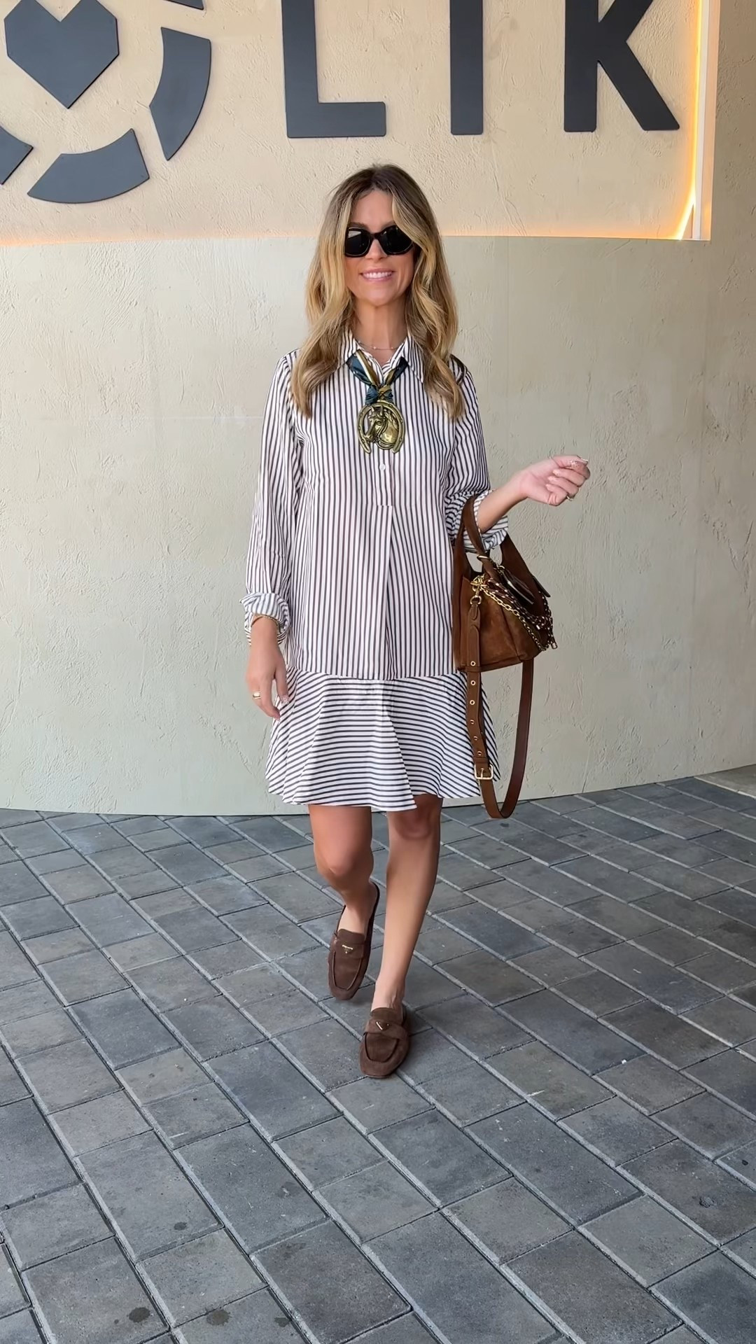 LTKCon outfit! Loving this Amazon dress for fall! Wearing size small 
Coach suede bag + Veronica beard bag charms 
Tom ford sunglasses 🕶️ 
Amazon scarf 
Etsy horseshoe 
Prada loafers 

#LTKCon #LTKStyleTip #LTKParties