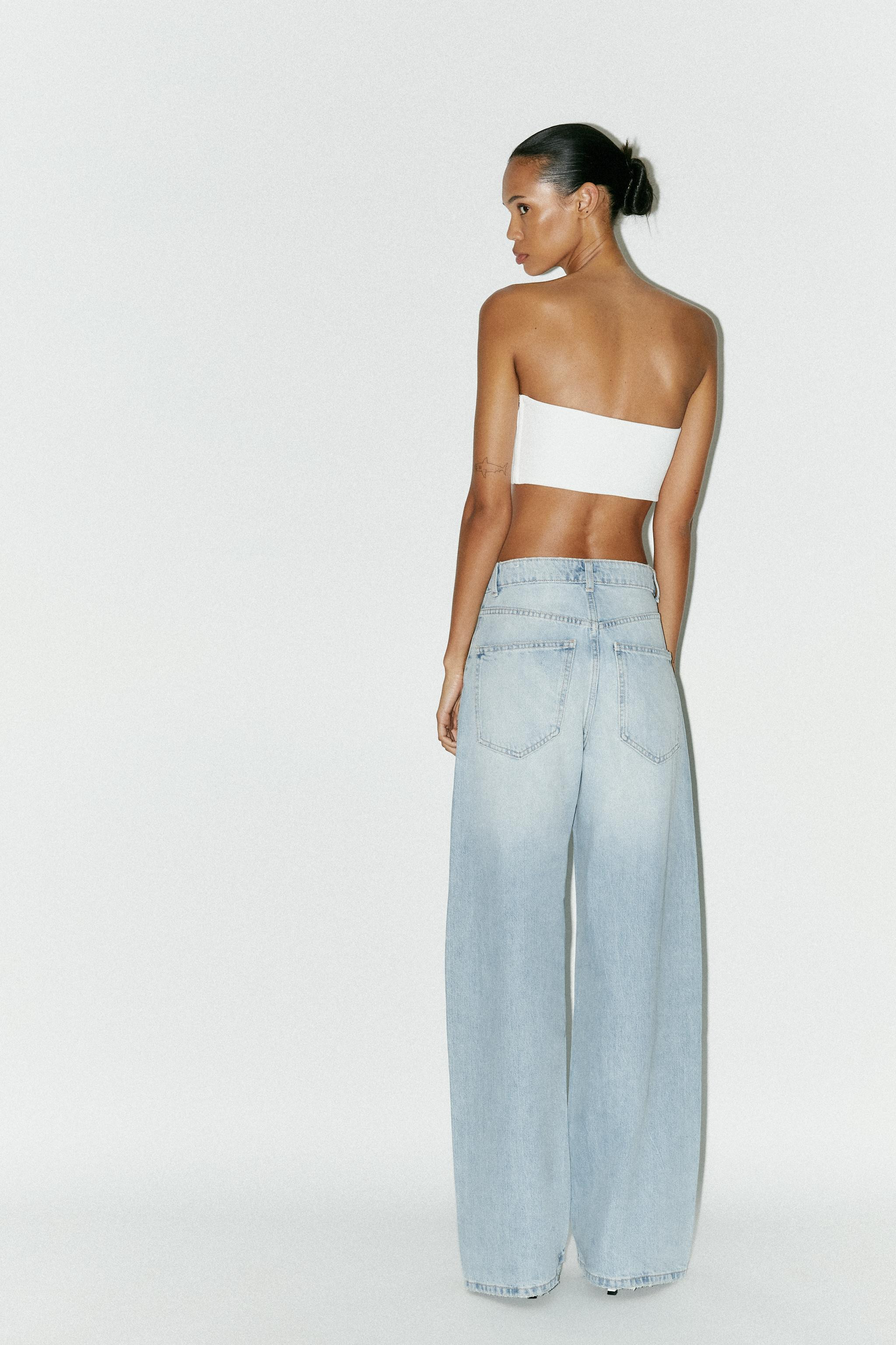 Asymmetric neck crop top with metal detail and jewel embellishment. Matching inner lining. Side m... | Zara UK