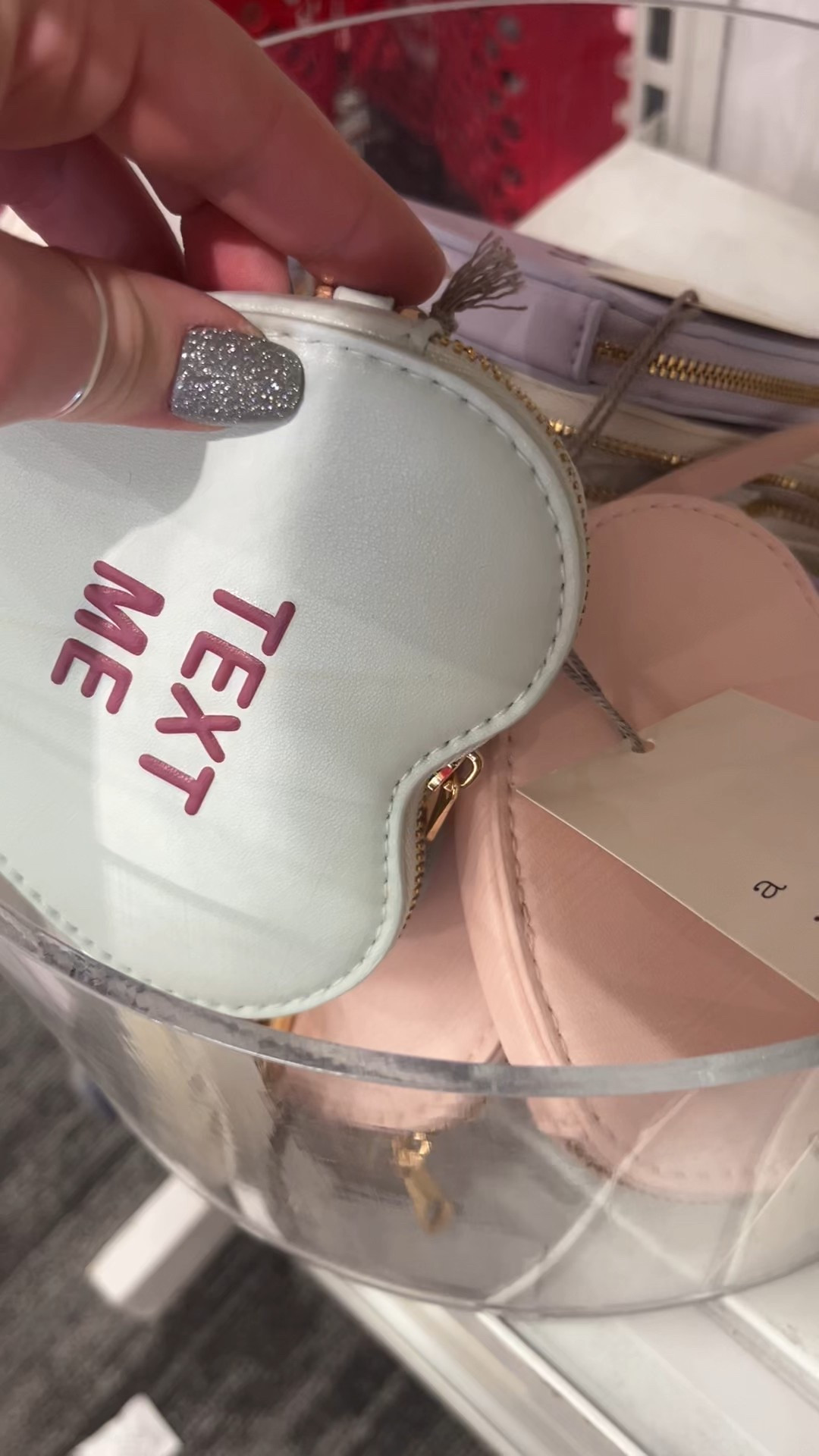 This conversation heart clutch purse is the perfect Valentine’s Day accessory and the cutest heart shaped change purse for date night, Galentine’s Day, or Valentine’s outfits. Designed as a conversation heart purse with a playful candy-heart look, this novelty heart clutch doubles as a mini purse or small clutch bag for going out.

I love this heart clutch purse as a statement accessory with neutral outfits, pink dresses, red outfits, or classic Valentine’s Day looks. Whether you’re styling it as a Valentine’s Day clutch, candy heart purse, or mini change purse, it’s a trendy handbag that instantly elevates any outfit.

Such a fun gift idea for her, Valentine’s Day gift, or Galentine’s Day gift—perfect for parties, weddings, girls’ night out, and special occasions. This statement clutch purse is playful, trendy, and totally conversation-starting 💖🍬

#LTKSeasonal #LTKFindsUnder50 #LTKootd