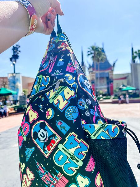 This sling backpack that I picked up at Walt Disney World to use as a park bag worked great! ✨ It’s also on Disney Store right now too! 🎉

This bright print is so fun! 💚

#LTKfindsunder50 #LTKtravel