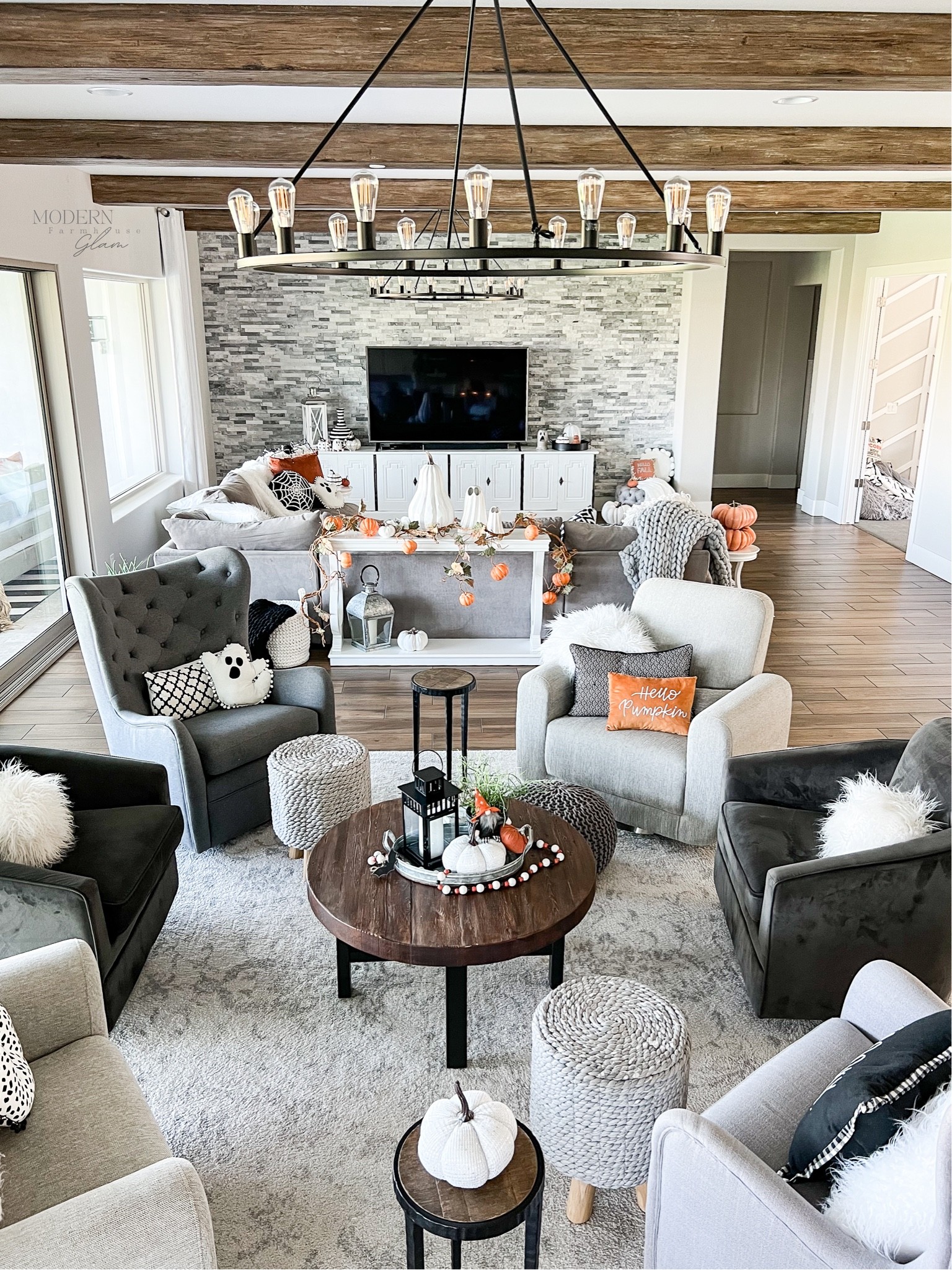 This is what we call The Conversation Area! Do you have a room like this in your home? 

It is the perfect spot for hanging out with friends and family. Our modern take on the traditional sitting room. Everyone gravitates to this area  

Squeezing in on a couch with company can be kind of awkward, right?! It’s nicer when everyone has their own chair. All of these chairs swivel and glide/rock, so it is a super comfortable spot for relaxing and talking. 

Which chair to you want? 

Sources for my home decor and furniture are linked on my website www.modernfarmhouseglam.com 

#homedecor #conversationarea #livingroom #modernfarmhouse #interiors #woodbeams #modernfarmhouseglam #interiordesign #falldecor #neutraldecor #homeinspo 
Coffee table. End tables. Wagon wheel iron chandelier, Lighting, pillows, sofa, sectional, couch, Halloween decorations, seasonal, fall decorations, Pottery Barn, Restoration Hardware, Wayfair, Amazon

#LTKSeasonal #LTKhome