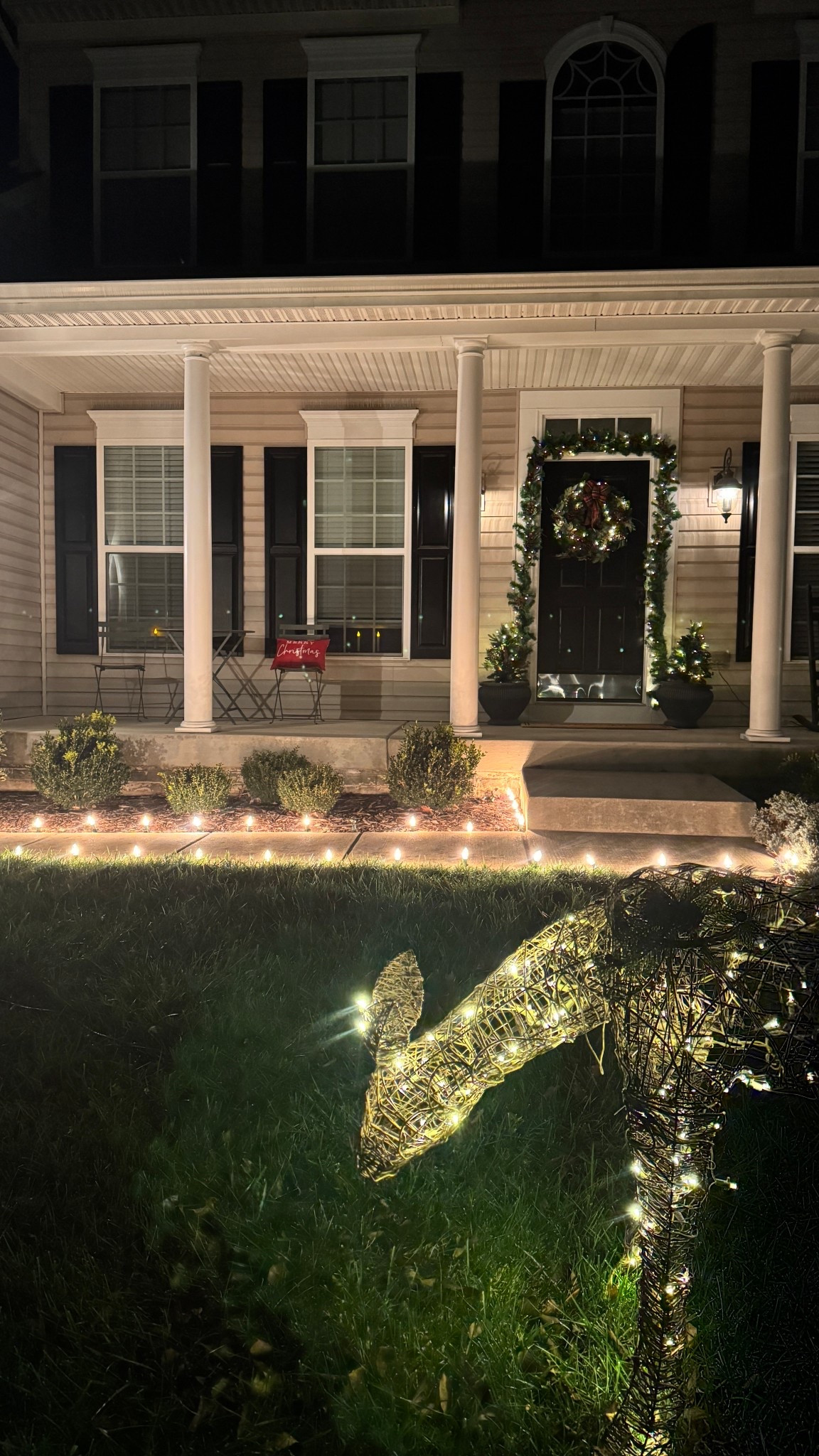 The Recipe for a Christmas Porch: festive wreaths and garland framing the doorway, cozy holiday throw pillows, glowing Christmas trees, and a beautifully lighted walkway to welcome guests all season long. #amazon #homedepot #target 