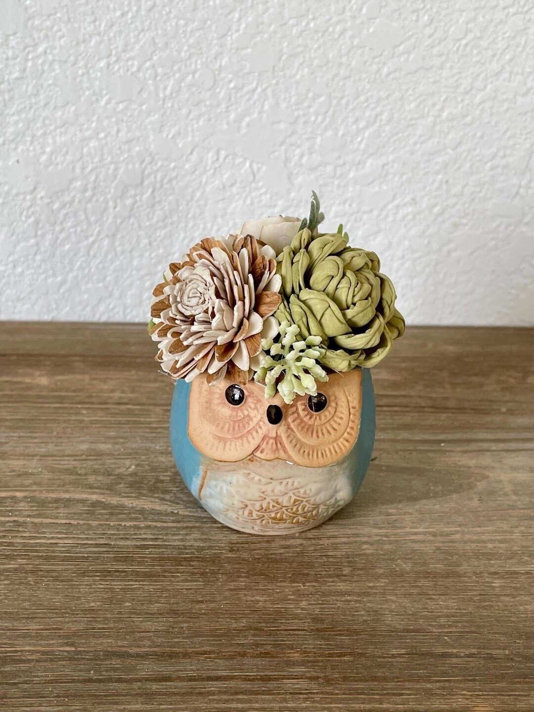 This adorable owl planter arrangement from TinyHouseDecor brings rustic woodland charm to any space. Standing about 4” tall, the mini planter is filled with carefully hand-dyed sola wood flowers crafted from natural tapioca root. The sweet forest-inspired design makes it a perfect accent for shelves, desks, or cozy corners—and a thoughtful little gift that will last for years. 🦉🌸 #ltkhome #ltkfinds #etsyfinds #rusticdecor #woodlanddecor #giftideas

#LTKSeasonal #LTKHome