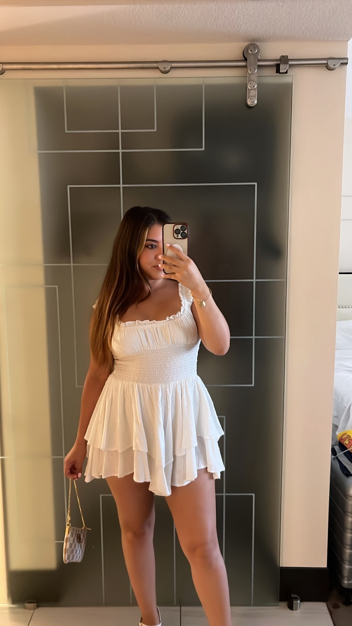 This look is the perfect summer outfit with a white smocked mini dress featuring tiered ruffle layers that give it a flirty and feminine vibe. The lightweight fabric and square neckline make it ideal for vacation style or a casual daytime date. Paired with a chic mini designer bag, this outfit is a must-have for LTK fashion finds to recreate that effortless, girly aesthetic.

#LTKSeasonal #LTKParties #LTKFindsUnder100