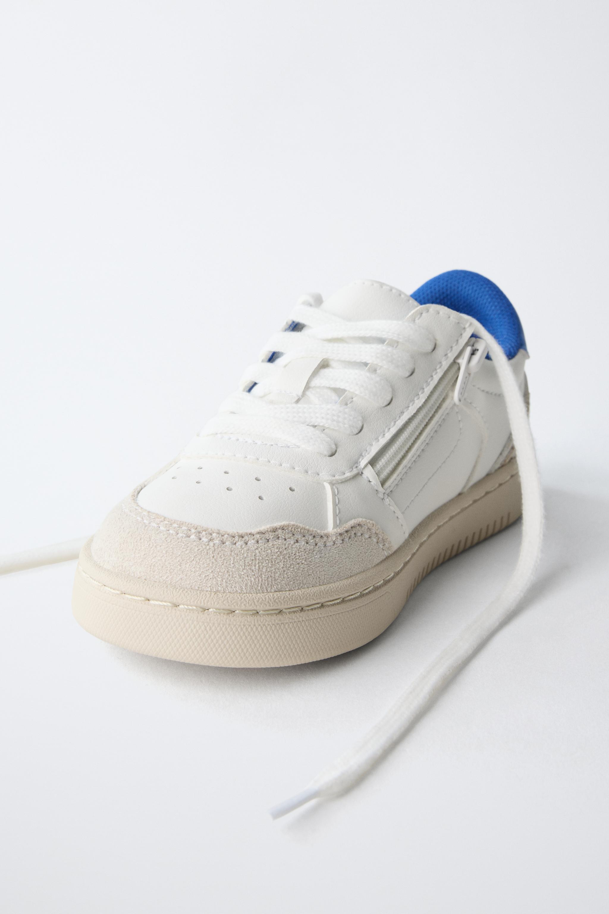 Leather sneakers with a contrasting color design. Features lace-up and side zip closure. Finished... | Zara US