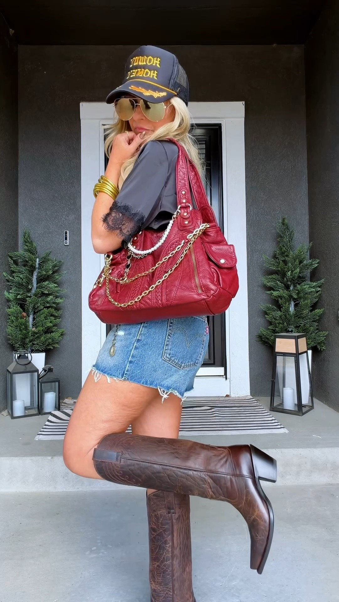 Modern western outfit with denim shorts, boots, a trucker hat, and a lace top. I love outfits that mix feminine details with a little western edge. The lace keeps it soft, the boots add character, and the trucker hat gives it that effortless, lived-in feel.

#LTKootd #LTKOver40 #LTKPetite