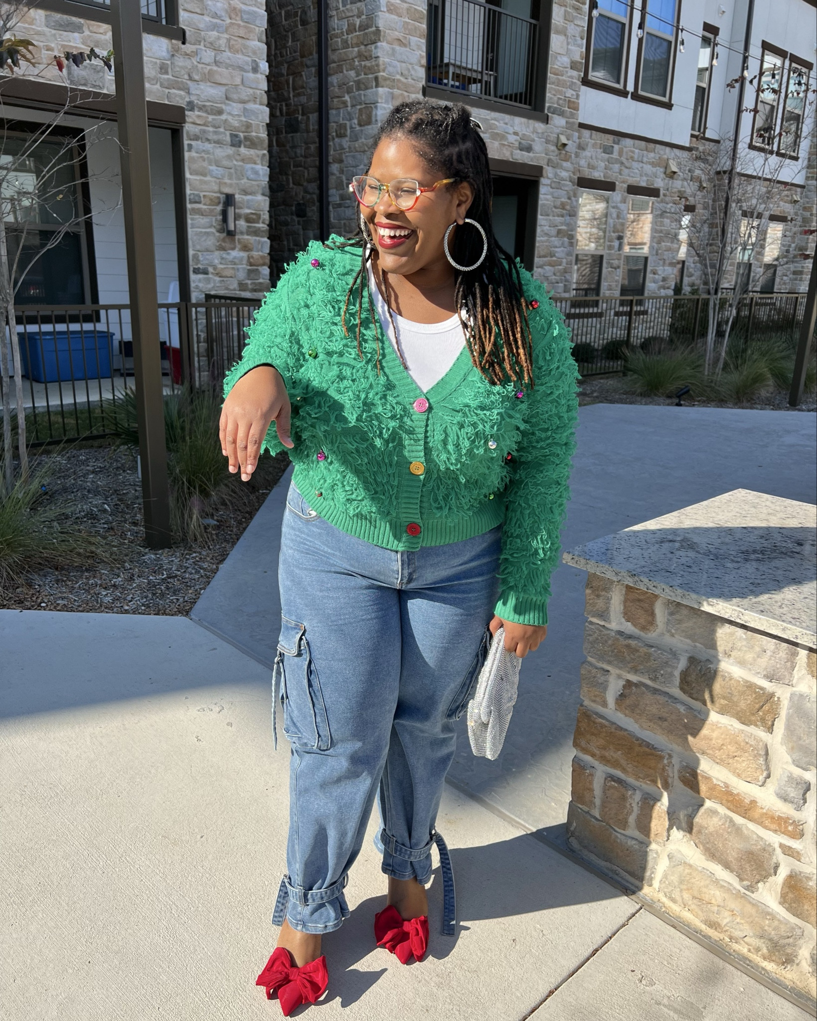 Outfit Theme: Oh, Christmas Tree 🎄 

When I saw this green cardigan at @target, it screamed ugly Christmas sweater, but make it cute! I was infatuated by the textured details and mini colorful bulbs. A true work of art okayyy. Kudos to @targetstyle for this cardi.

Finding the perfect bottoms to pair with it was a little difficult because the cardigan was boxy and cropped which is not the most flattering silhouette on a pear-shaped body, but I eventually decided on these cargo jeans. The structured vibe balanced the shape out.

To take the look up a notch, I added these red bow heels (also from Target)—an ode to the classic Christmas bow. They instantly tied the whole outfit together (pun intended) 🤭

For accessories, I kept it festive with sparkly earrings and a shimmering handbag from @shopakira, adding the perfect touch of holiday glam. I would be remiss if I didn’t mention my colorful frames from @zeelool They’re actually prescription but they went perfectly with the outfit 😍

#LTKHoliday #LTKPlusSize #LTKStyleTip