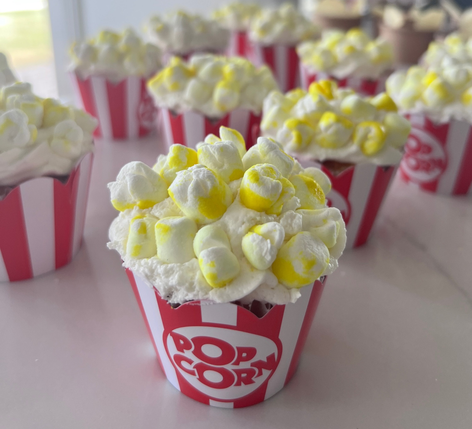 Popcorn cupcakes ! Made with all natural Watkins food coloring & mini marshmallows. The cupcake holders complete the look! 