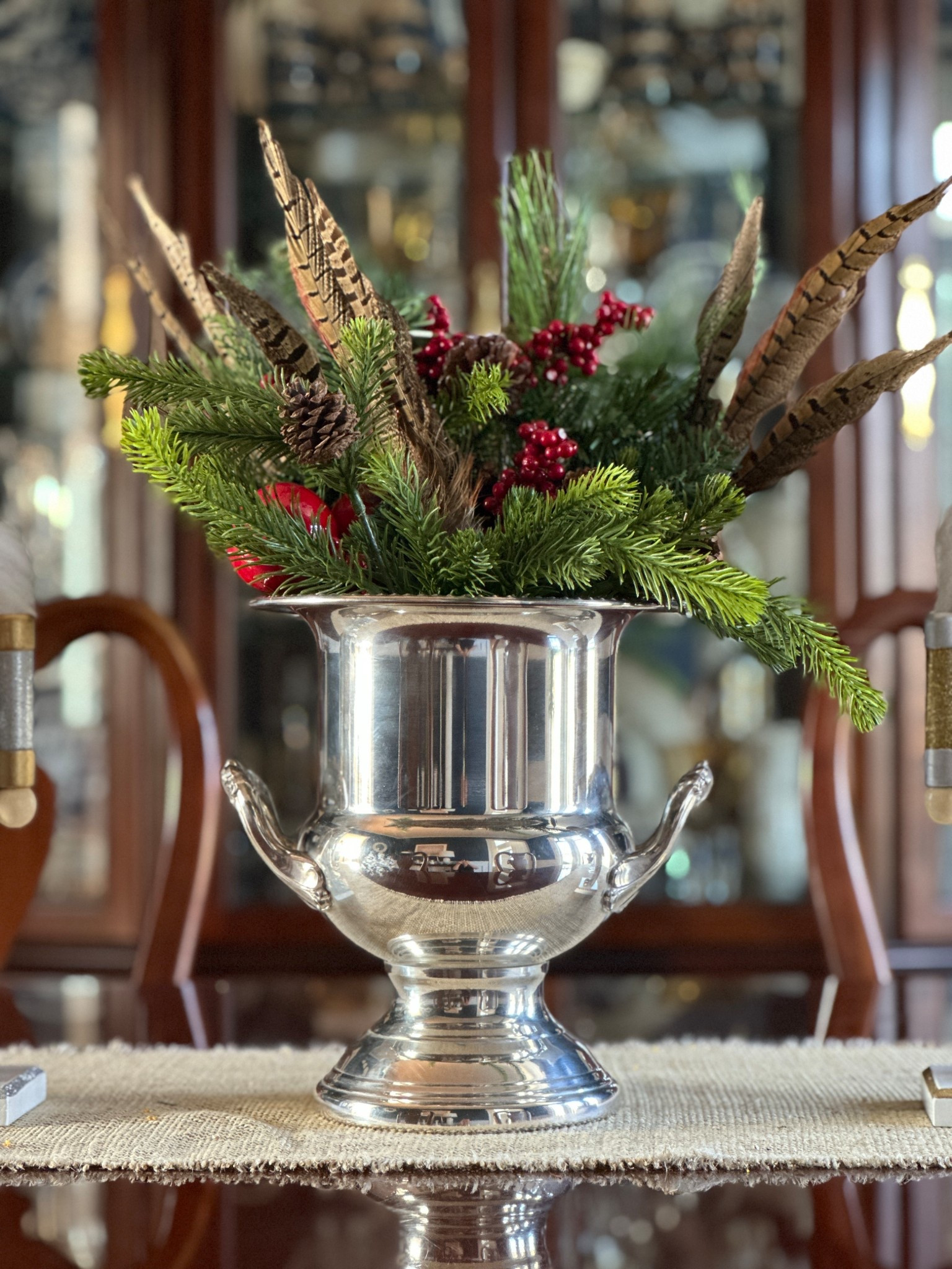 Silver urn / ice bucket with Christmas greenery and feathers for a Ralph Lauren Christmas centerpiece.

#LTKHome #LTKHoliday #LTKSeasonal