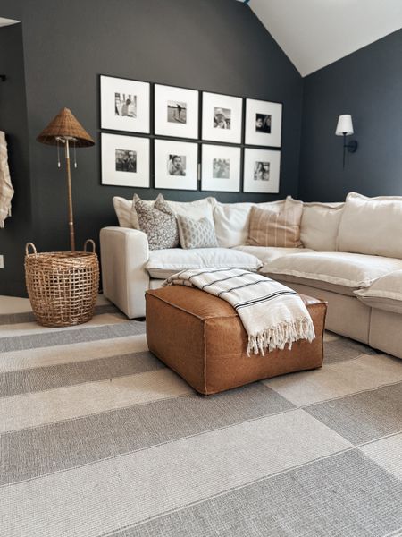 Shop our loft space here! The code LINSEYW will always save you 5% off Homebody sofas 🫶🏼

Gallery wall, coffee table ottoman, woven floor lamp, Sophie blanket, floral pillows, neutral decor, ruffled thread, woven nook, wall scones, amazon, media console, tv stand, woven cabinet, striped rug 

#LTKfindsunder100 #LTKhome