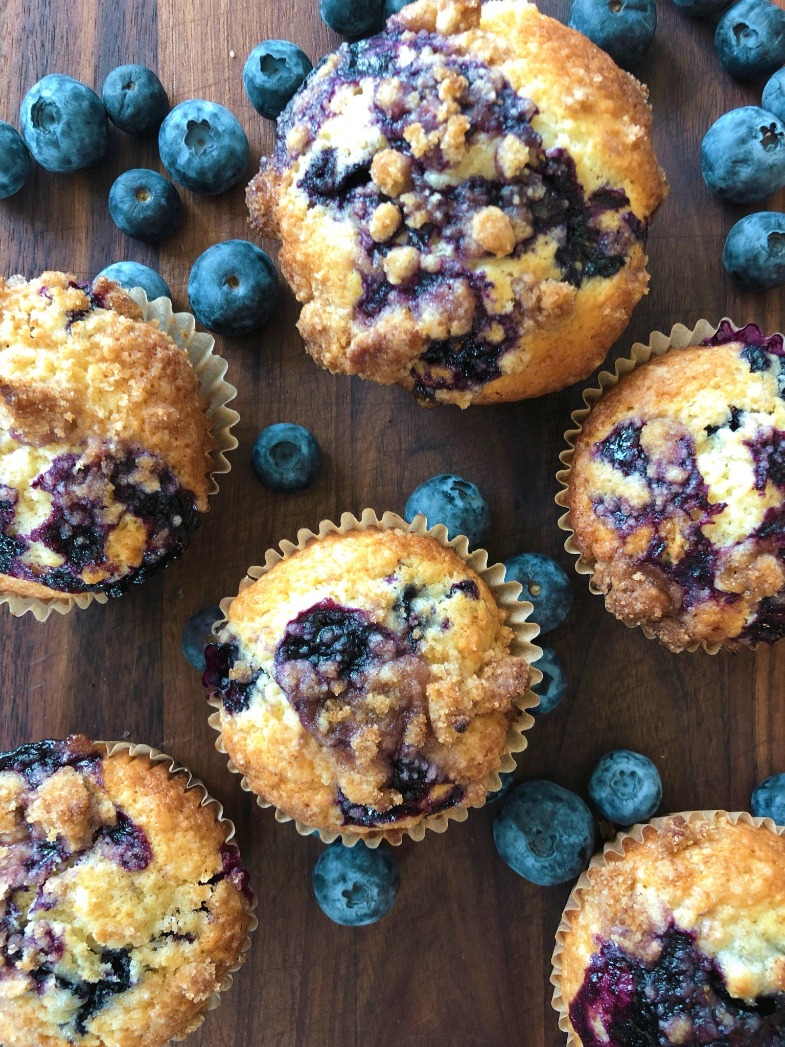 Blueberry Muffins

Blueberry Muffins

2 cups flour, plus 1 tbs for dusting blueberries with
2 tsp baking powder
1/2 tsp salt
1 1/4 cup sugar
1 stick of butter, melted and cooled
2 eggs
2 tsp vanilla extract
1 tsp lemon juice
1/3 cup half and half
1/3 cup sour cream
1 1/2 cups fresh blueberries

Blueberry drizzle
1/2 cup blueberries
1 tbsp sugar
1 tsp lemon juice

Add everything to a saucepan, and bring to boil, stirring frequently. Reduce to a simmer and break apart berries with a spoon until all berries have burst about 8 minutes. Let cool. 

Crumble topping
1/4 cup flour
1/4 cup brown sugar
Zest of 1/2 lemon
3 tbs melted butter

Combine the dry ingredients, and mix well. Pour in melted butter and mix until it looks like small peas. Set aside. 

Muffins
Make blueberry drizzle and crumble topping first, and set aside. 
Preheat the oven to 425. Add parchment muffin liners to a muffin tin. 
In a mixing bowl combine flour, baking powder, and salt. 
In another mixing bowl combine butter, sugar, eggs, vanilla, sour cream, half and half, and lemon juice. Mix until well combined and sugar is dissolved. 
Gently fold the wet ingredients into the dry ingredients until just combined. 
Sprinkle washed and dried blueberries with 1 tbs flour, to coat each one. This will help them distribute evenly in the muffins and not sink to the bottom. 
Fold in until just combined.
Use a cookie scooper to fill the ungreased muffin cups, filling them until it hits the brim of the liner. 
Drizzle a small amount of the syrup onto each muffin, then top with the crumble mix onto each one. 

Bake a 425 for 15 minutes, then reduce heat to 350 and bake for about 5 more minutes until done, and the topping is just turning golden brown. Be careful not to overbake, it will burn easily. 
Let cool in the muffin tin for 15 minutes, then transfer to a cooling rack until completely cooled. 
Makes 12 muffins

#LTKFamily