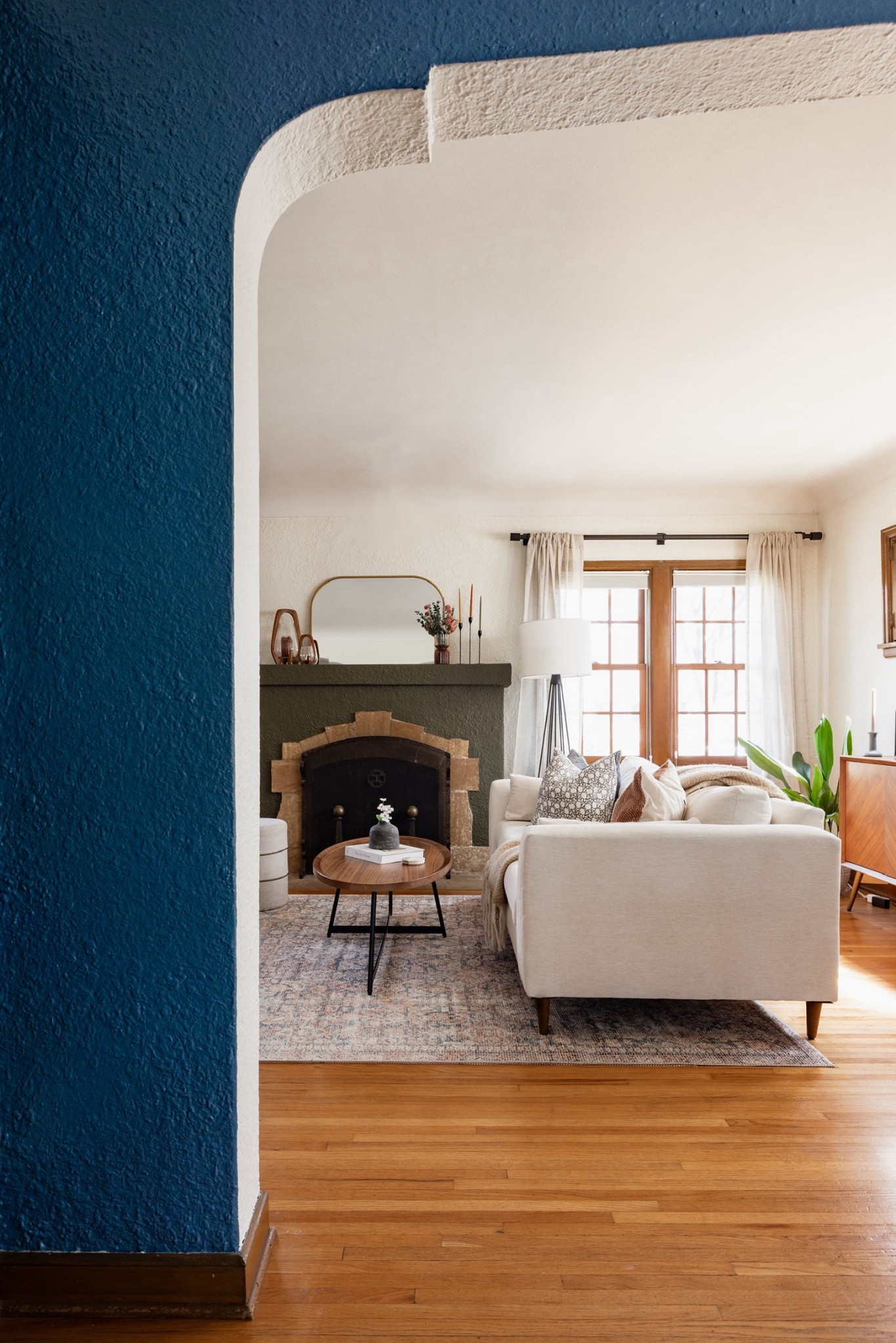 Old-home charm meets everyday comfort in this living room. We highlighted the architectural details with paint, then layered in a neutral sofa, patterned rug, linen curtains, and walnut coffee table, for a cozy, light-filled living room.

#LTKFindsUnder100 #LTKHome #LTKSaleAlert