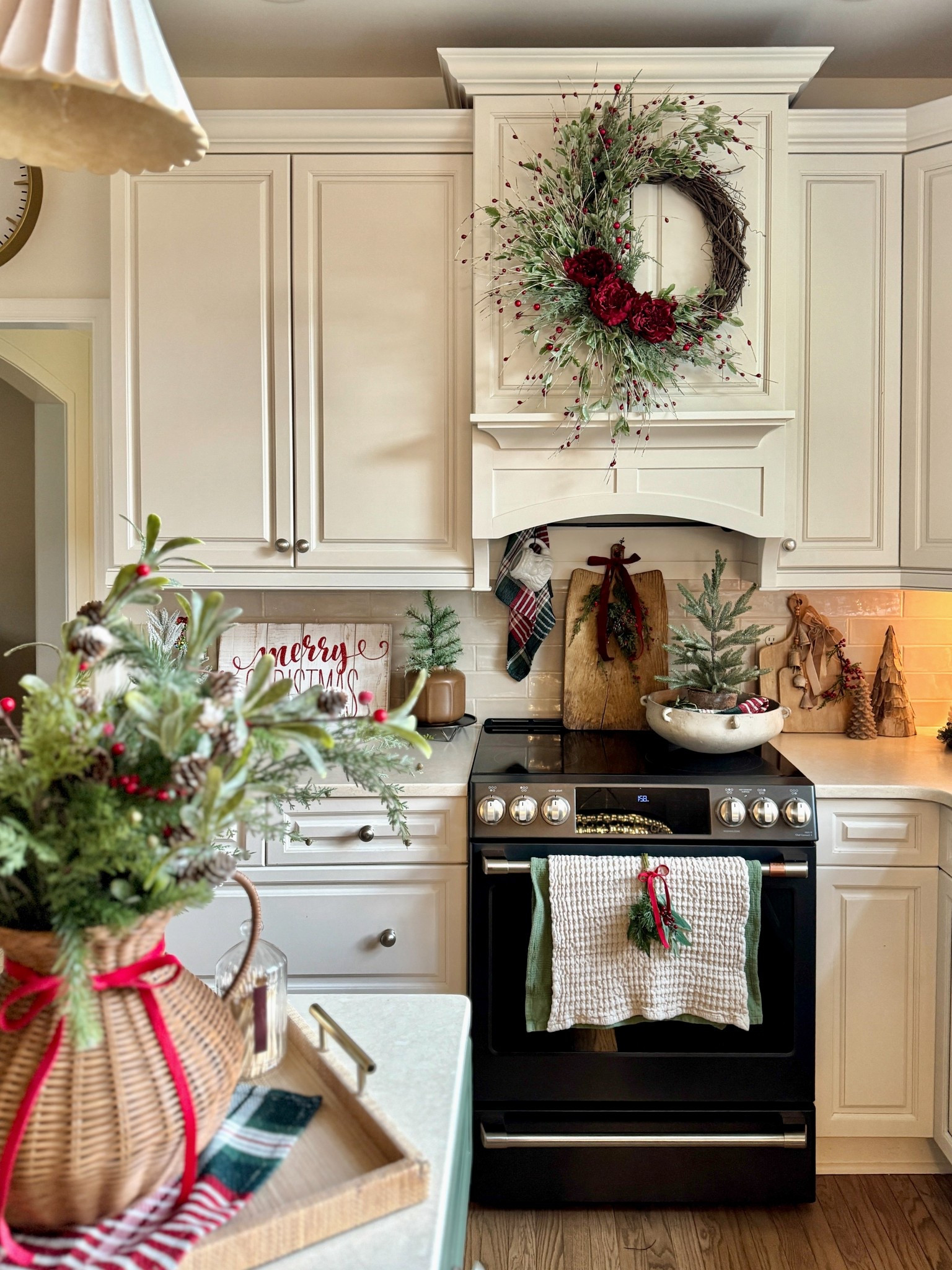 Shop my Christmas kitchen faves! 24” winter wreath with greenery, red berries and florals currently on sale. Green and red plaid napkins, mini swags set of 4, ribbon and premade bows, waffled towels, woven vase, candle warmer, vintage bread board, white Santa mug. Also sharing the magnetic curtain rod I bought for behind our stove in place of a pot rail so we didn’t have to drill holes in our custom vent hood. 

#LTKSaleAlert #LTKFindsUnder50 #LTKHome