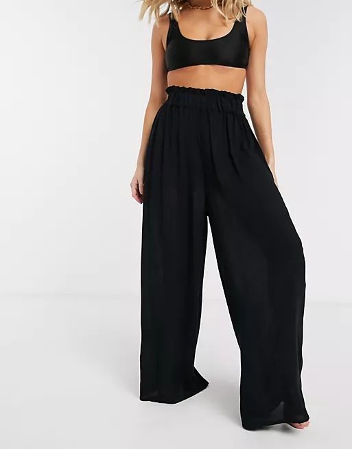 ASOS DESIGN crinkle wide leg palazzo beach pants in black | ASOS (Global)