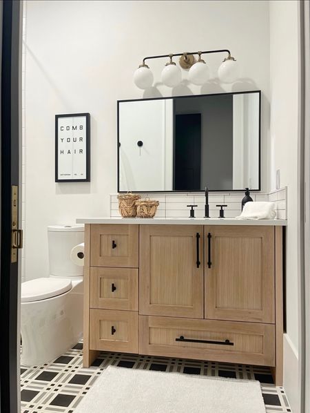 Bathroom decor. Cabinet hardware. Vanity lights. Black metal frame mirror.  Plaid tile. Boys bathroom.  White Organic bath towels.  White organic bath mat.  Bathroom signs.  White oak bathroom cabinet

#LTKunder50 #LTKhome #LTKstyletip