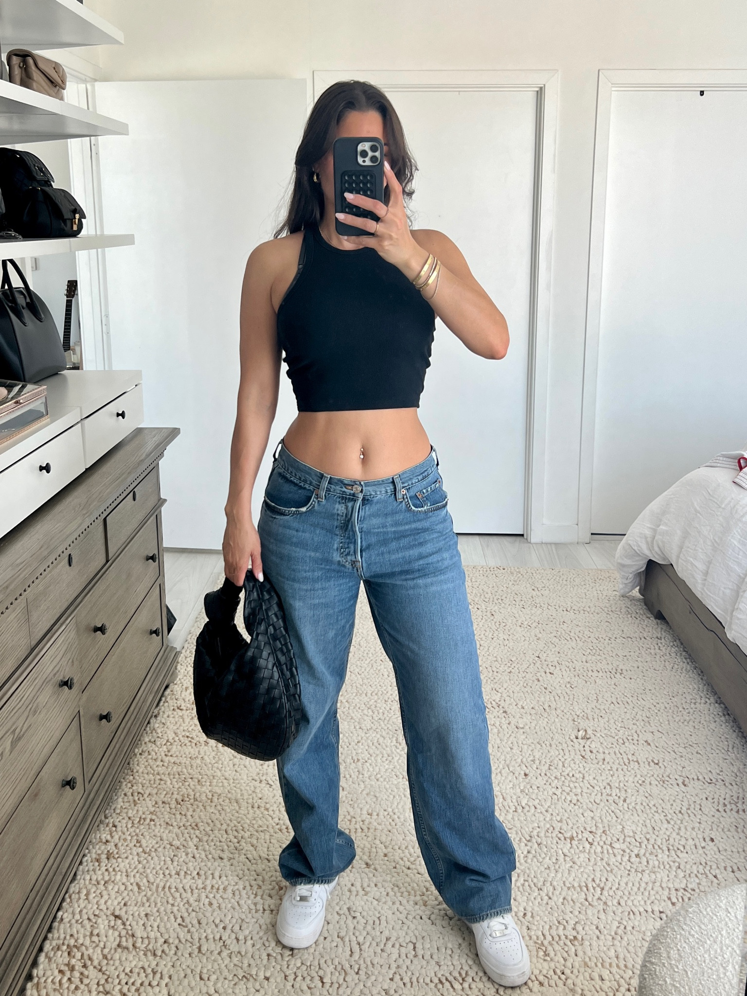Low rise wide leg denim jeans. 
Nike sneakers, H&M blank tank top and Bottega Veneta Teen Jodi 
