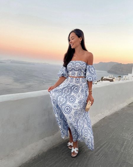 Kat Jamieson wears a blue and white set from a shop in Greece, similar below! Vacation style, warm weather, Santorini, getaway, floral, off the shoulder, neutral clutch. 

#LTKSeasonal #LTKtravel