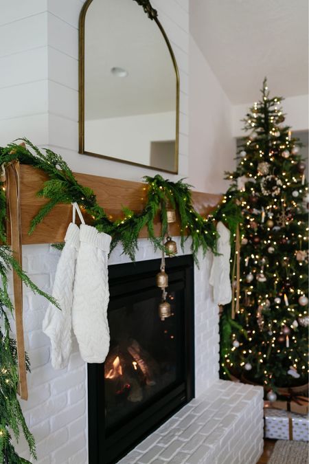A simple Christmas mantel look you can easily replicate using just faux cedar garland, fairy lights, ribbon, stockings and bells. 
Christmas decor 

#LTKhome #LTKHoliday #LTKfindsunder100