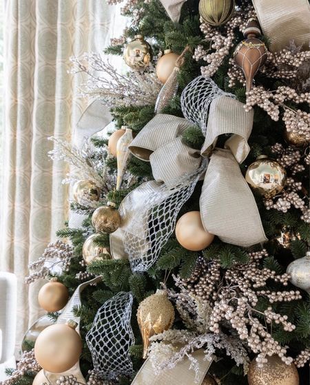 I styled this tree using a champagne ribbon that goes silver or gold depending on how you style it! Add gold ornaments and gold tree picks for a beautiful green artificial christmas tree design!


#LTKSeasonal #LTKHoliday #LTKhome